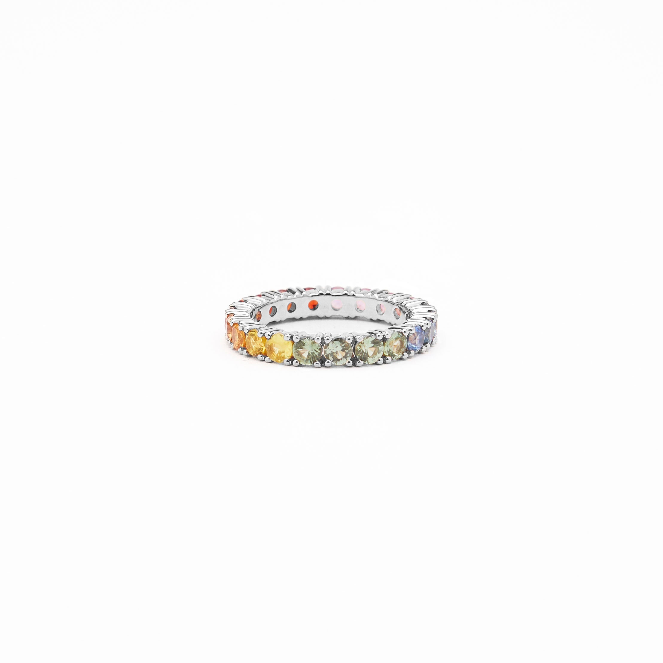 Beautiful eternity rainbow sapphires ring in white gold on white background.