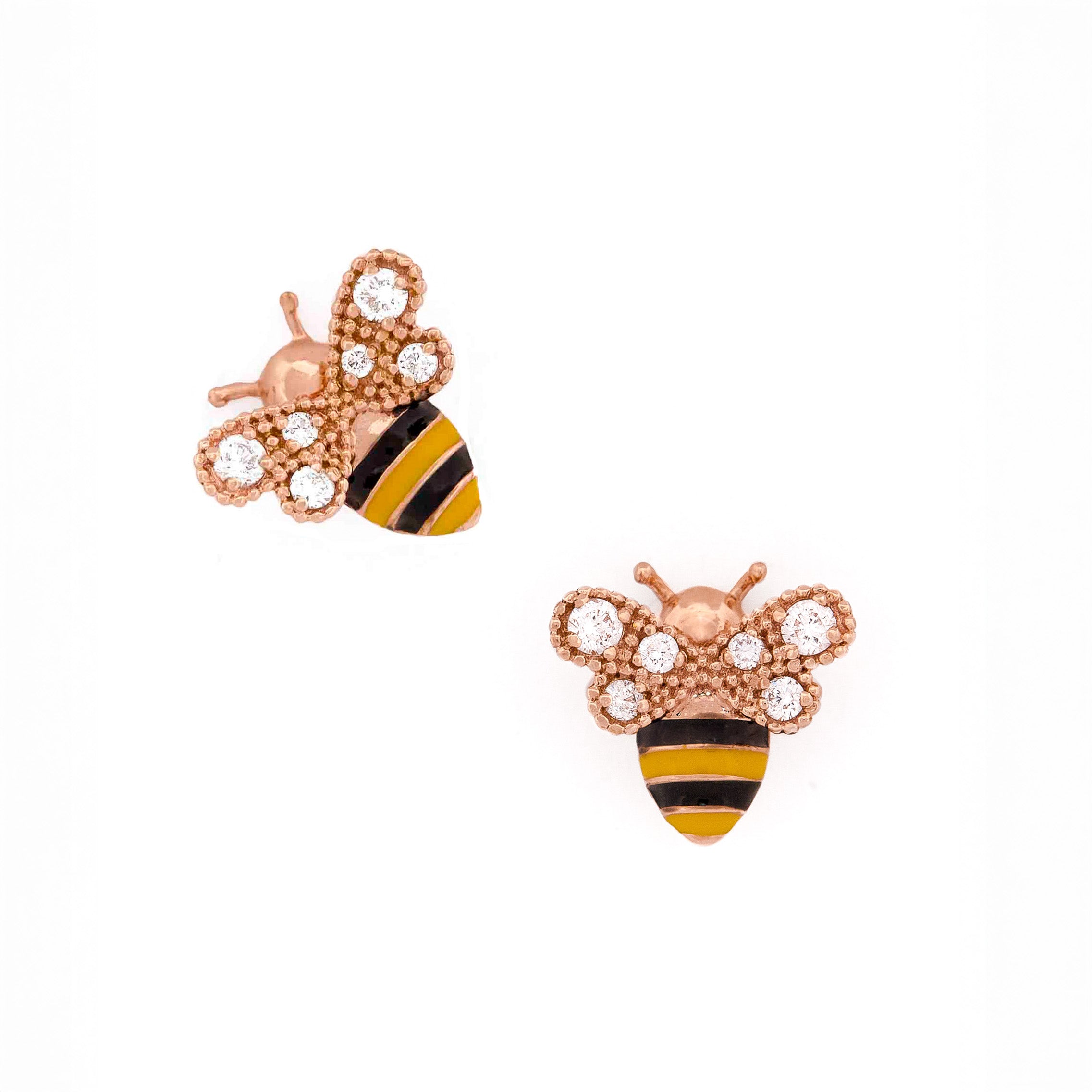 Gold bee-shaped earrings with black and yellow enamel and round diamonds on wings stripes on a white background