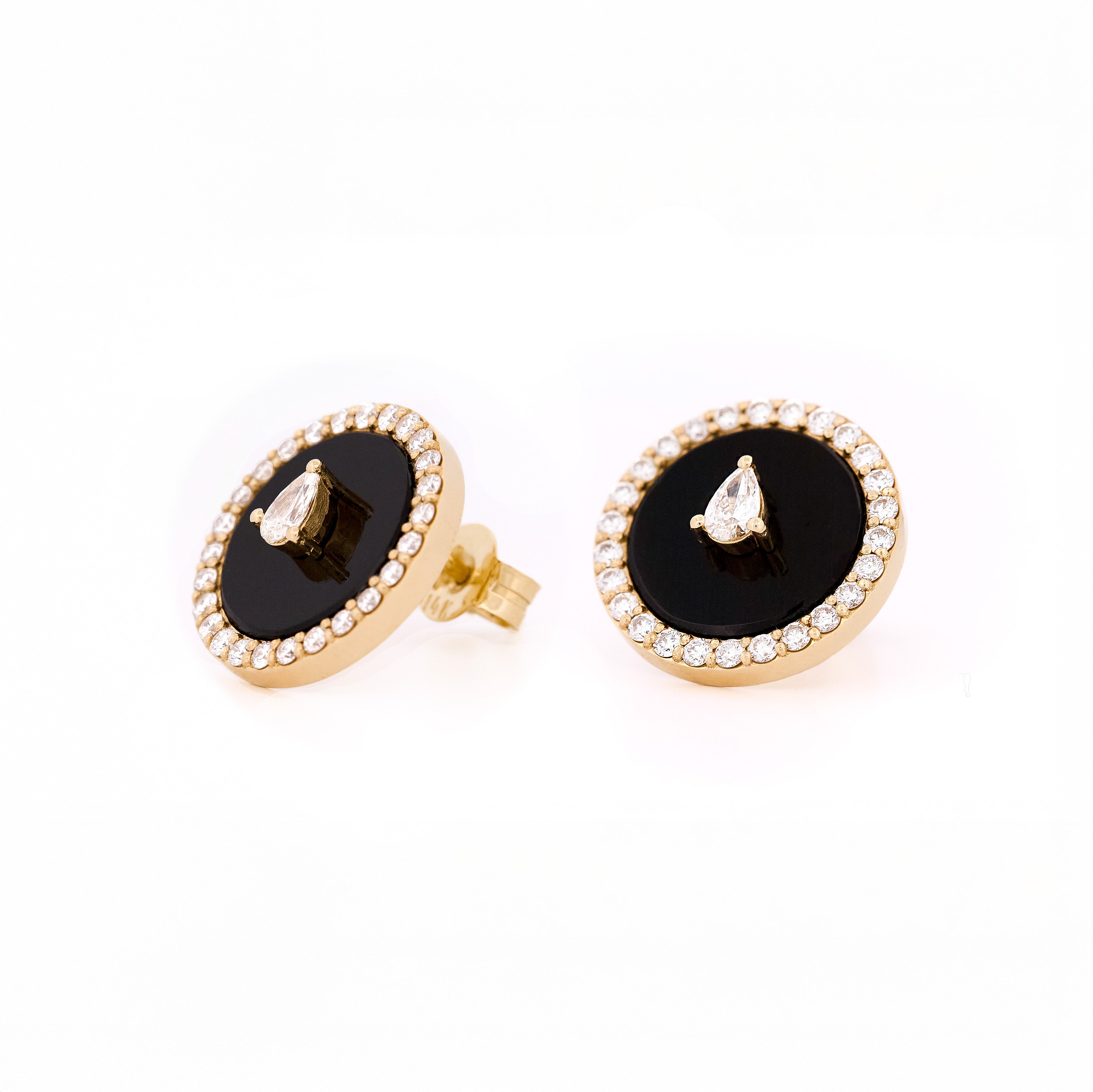 Pair of earrings with black onyx center stone and teardrop and round shape diamonds accents on a white background