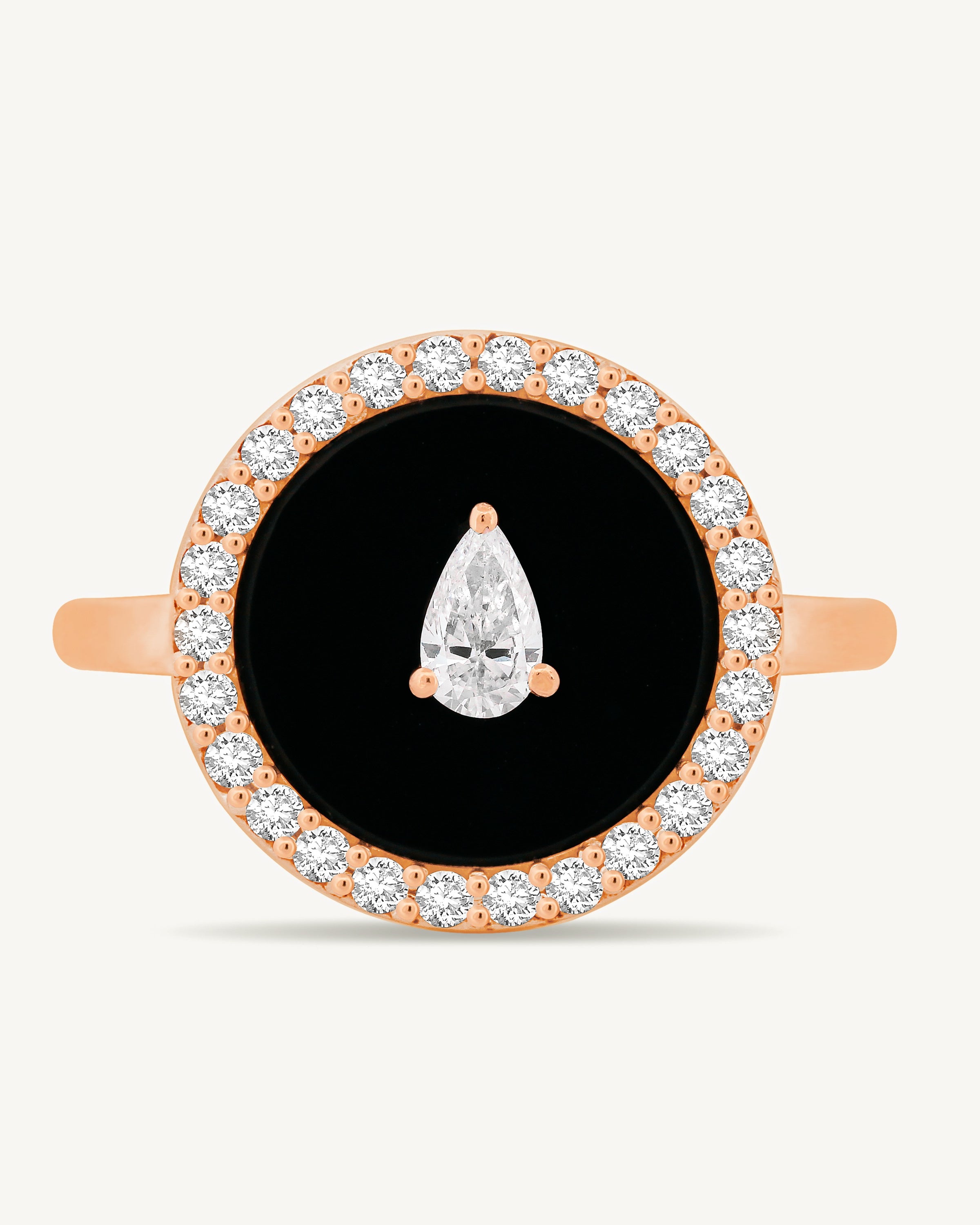 Rose gold ring with black onyx center and diamond accents on a white background