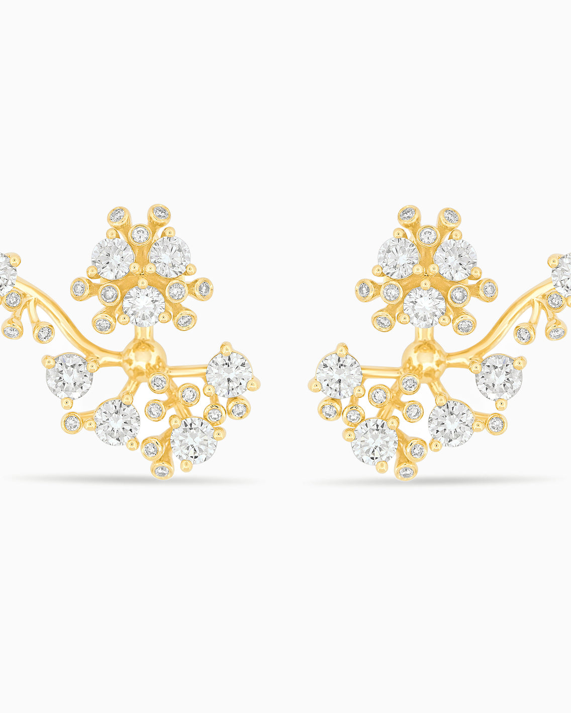 Gold and diamond bloom earrings against a white background.