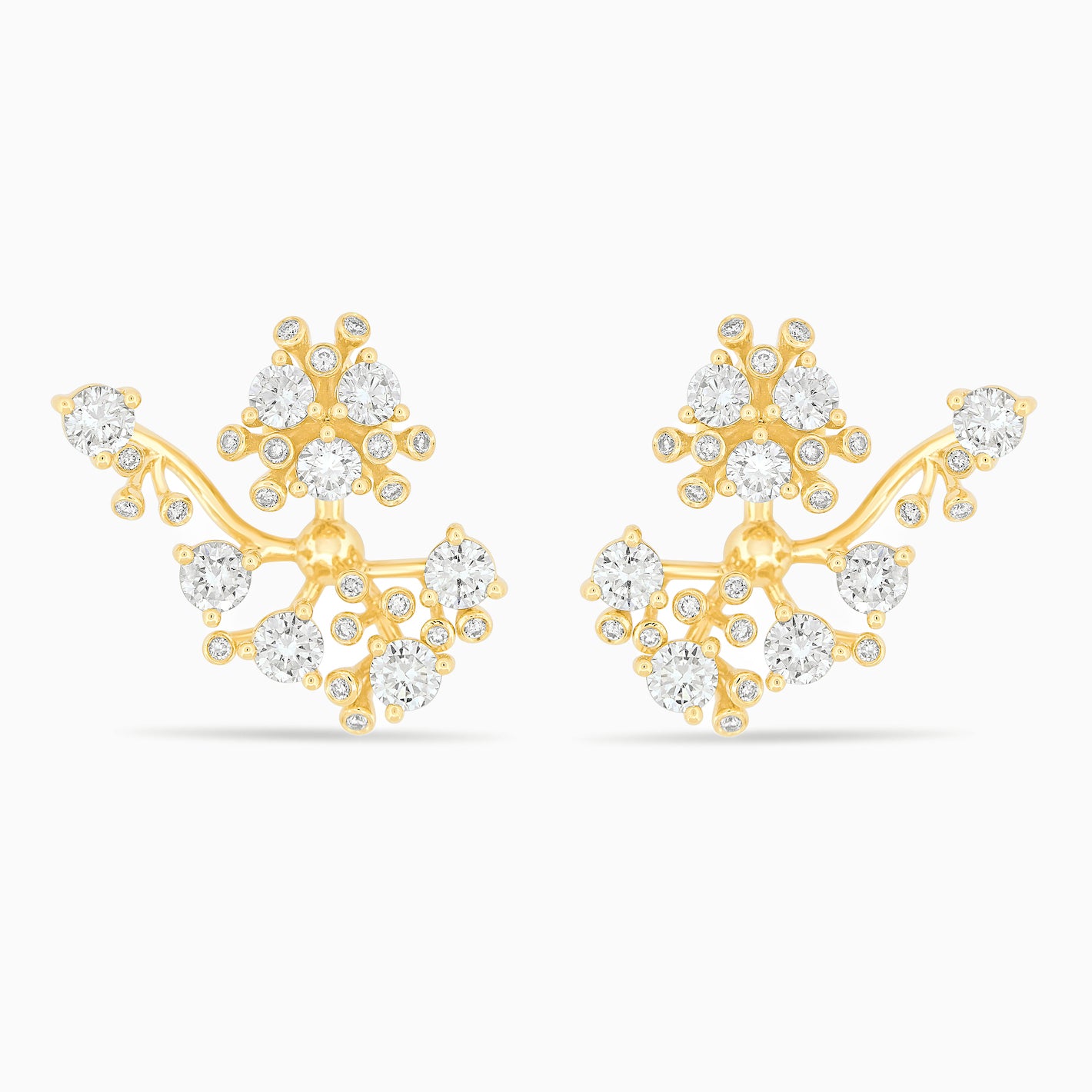 Gold and diamond bloom earrings against a white background.