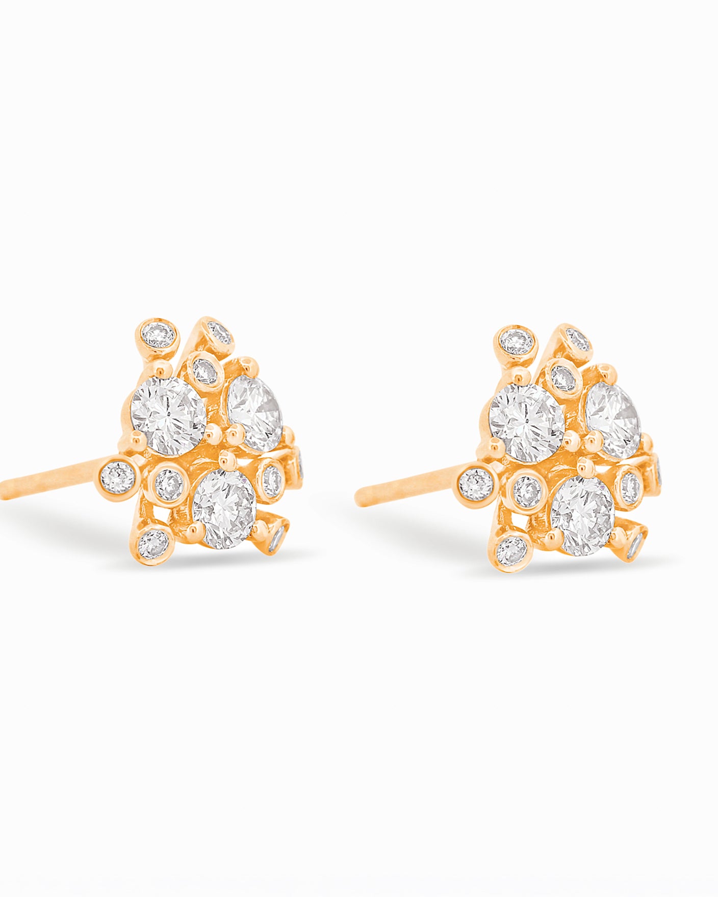 Gold and diamond bloom earrings against a white background.