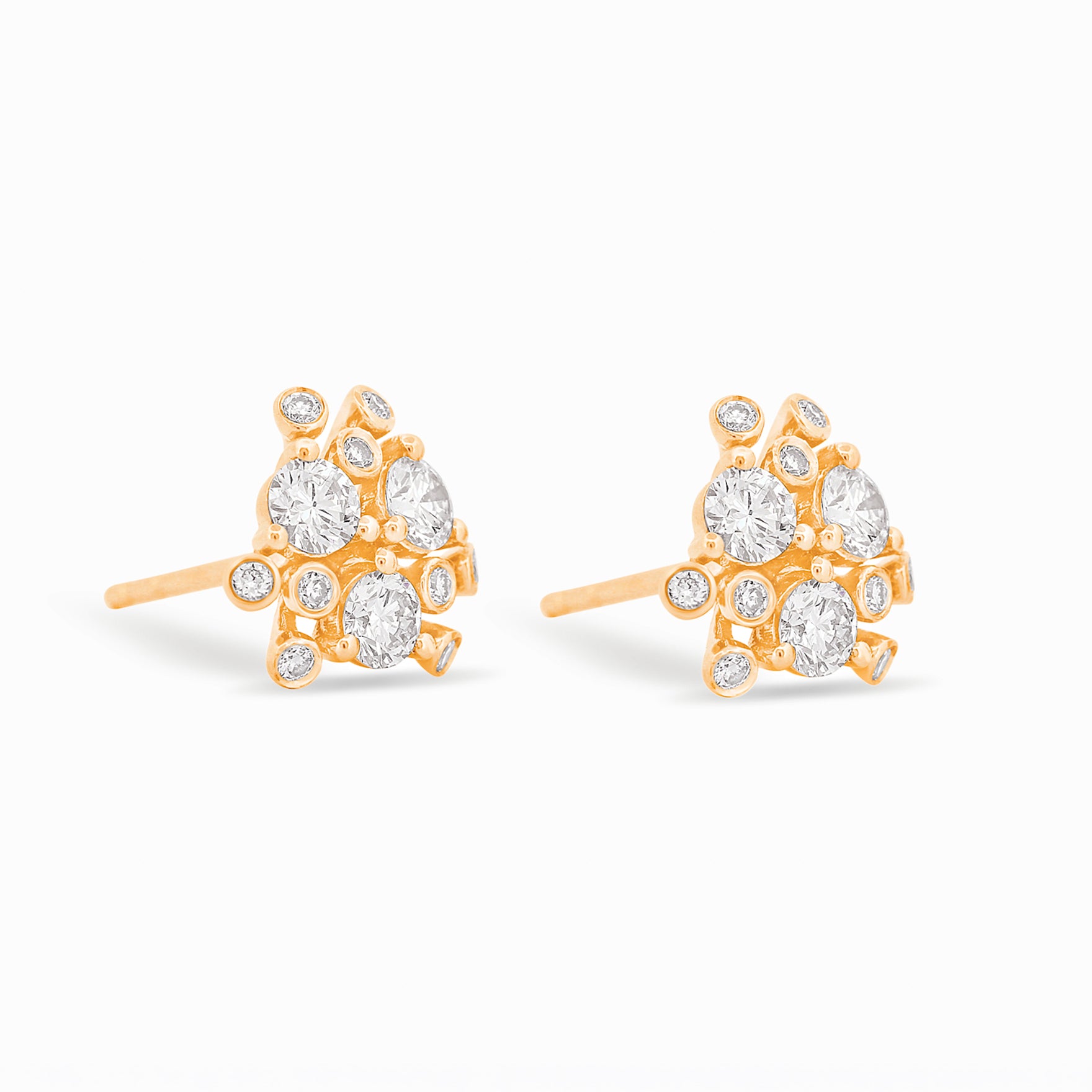 Gold and diamond bloom earrings against a white background.