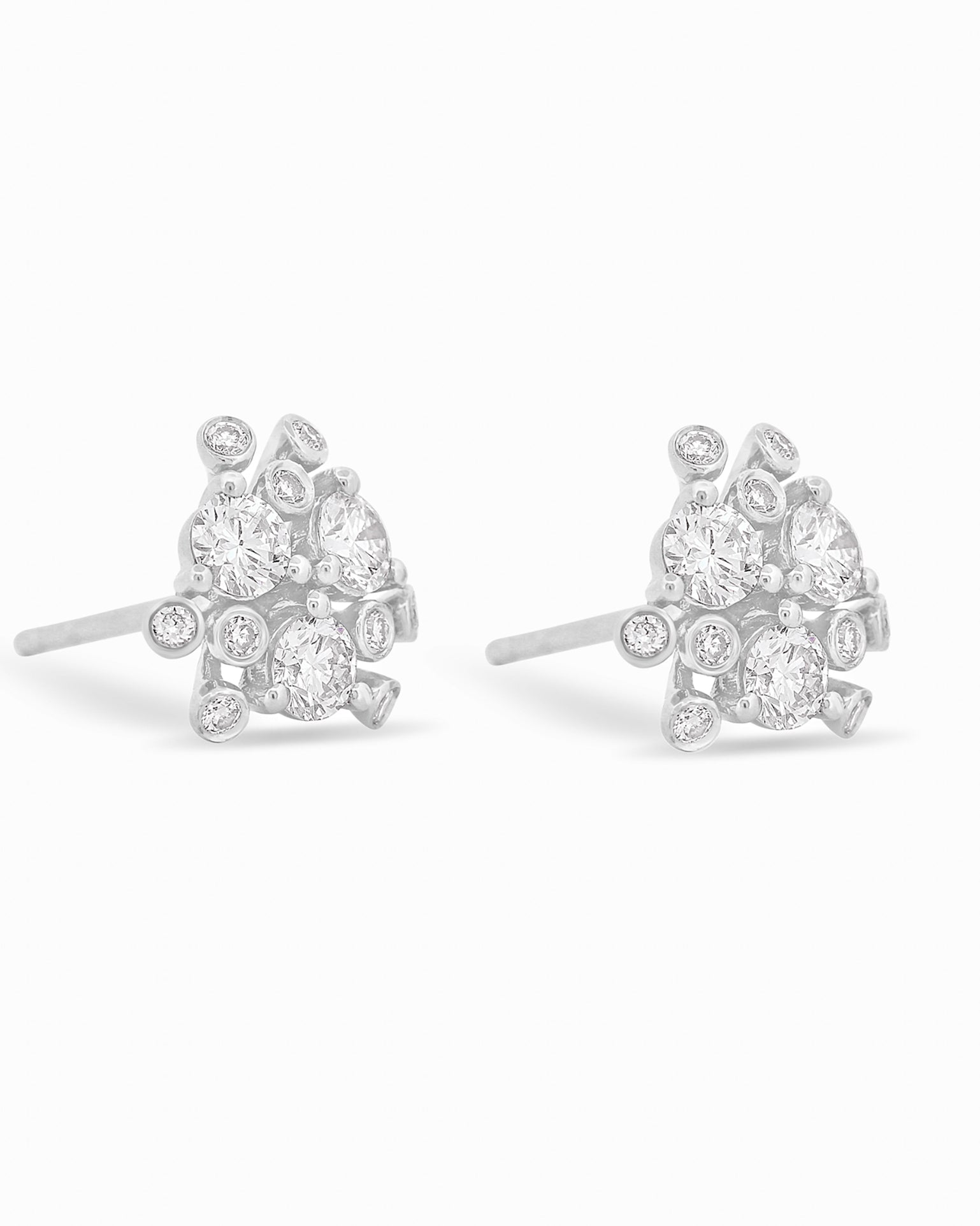 Gold and diamond bloom earrings against a white background.