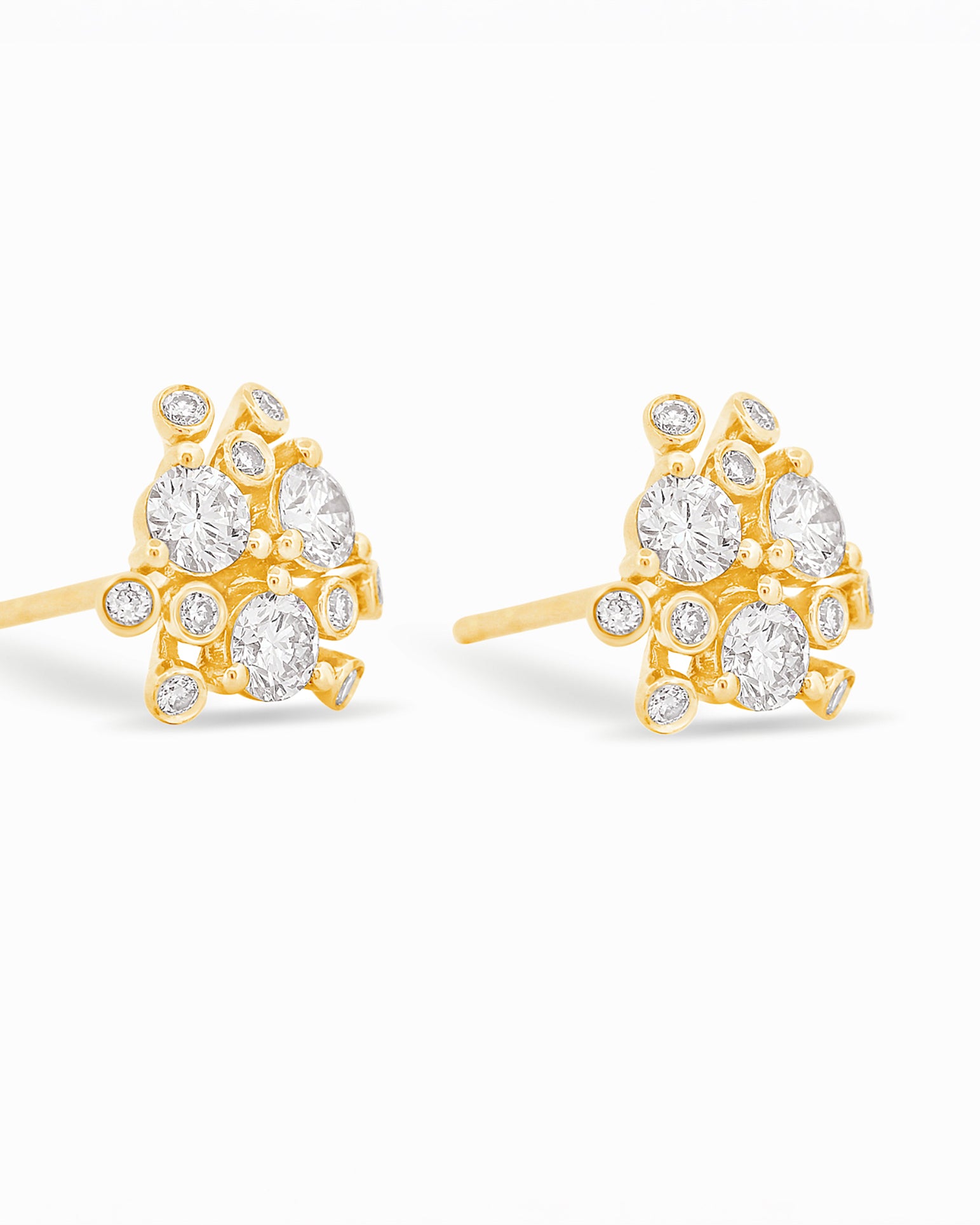 Gold and diamond earrings on a white background.
