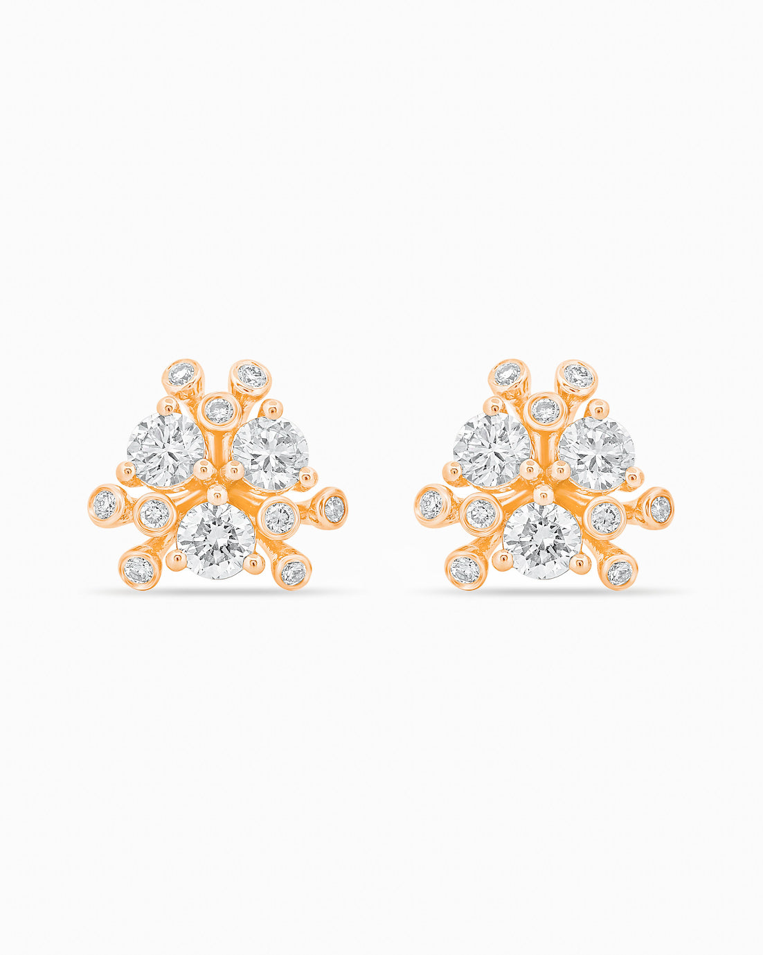 Gold and diamond earrings on a white background.