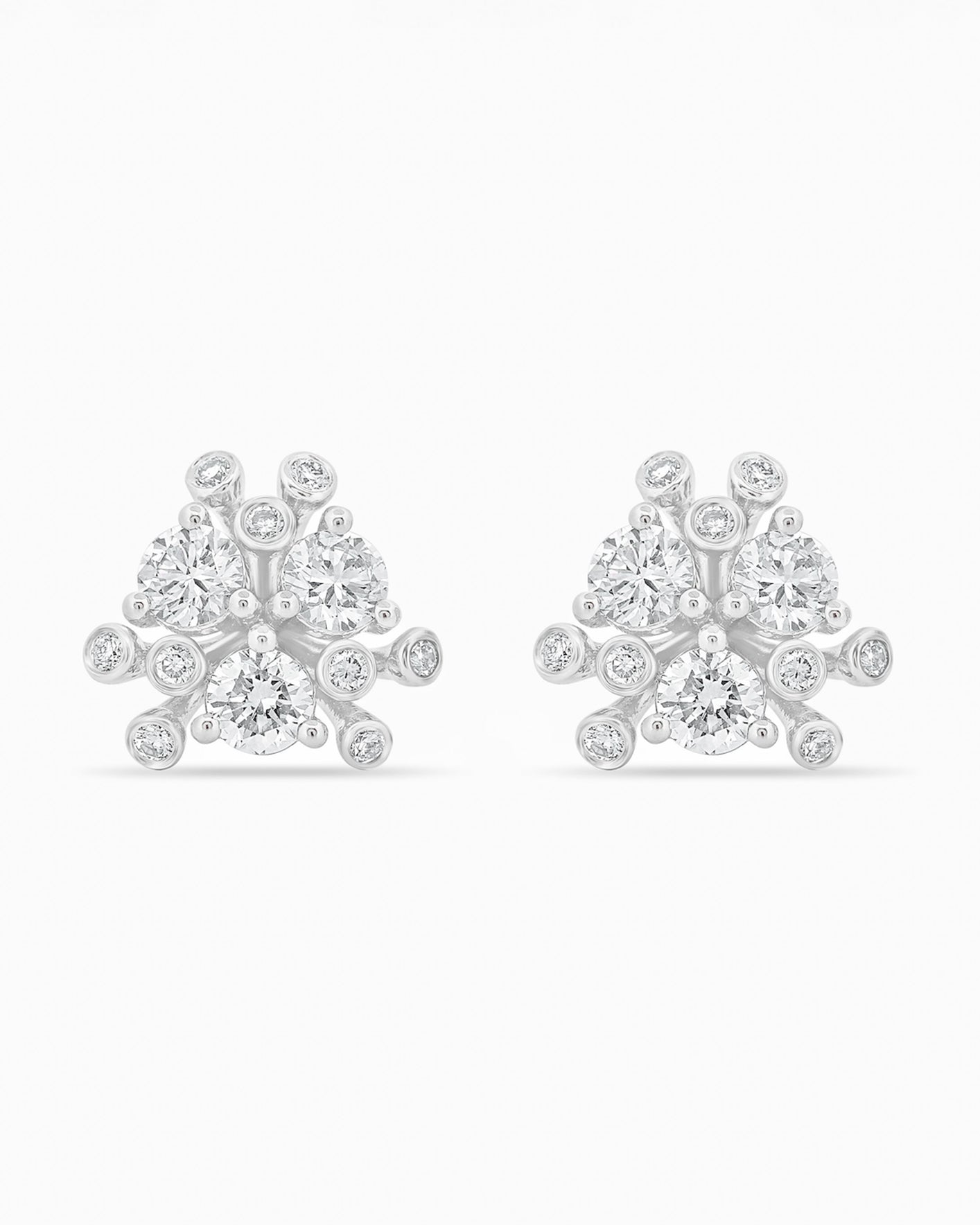 Gold and diamond earrings on a white background.