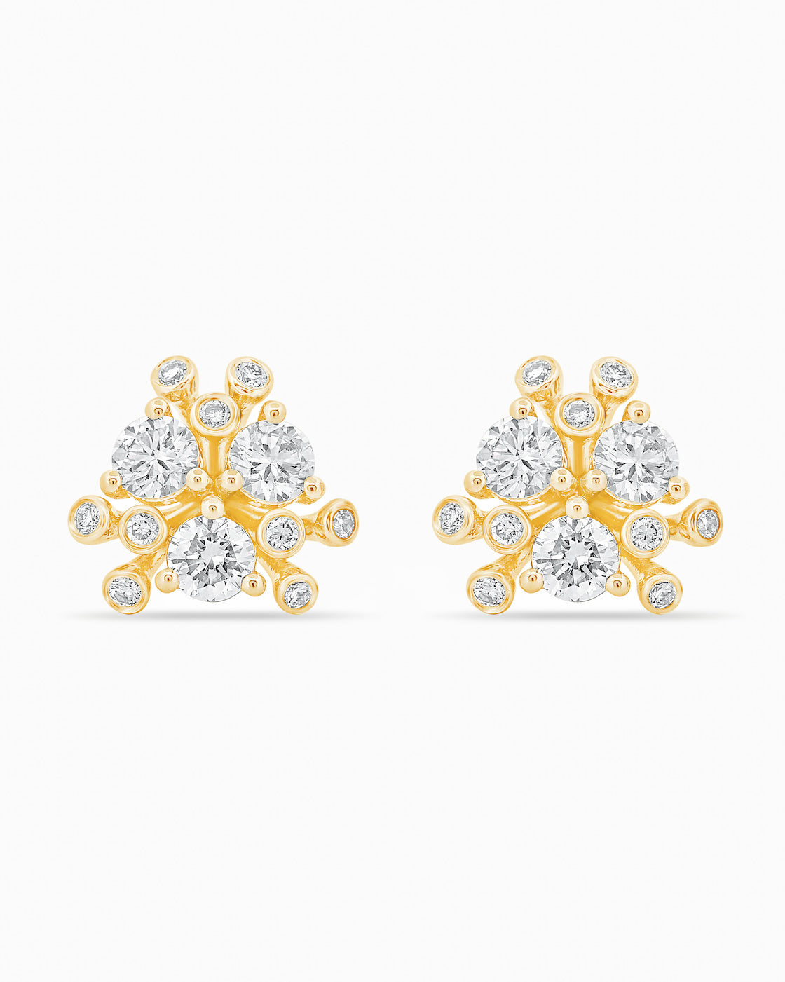 Gold and diamond earrings on a white background.