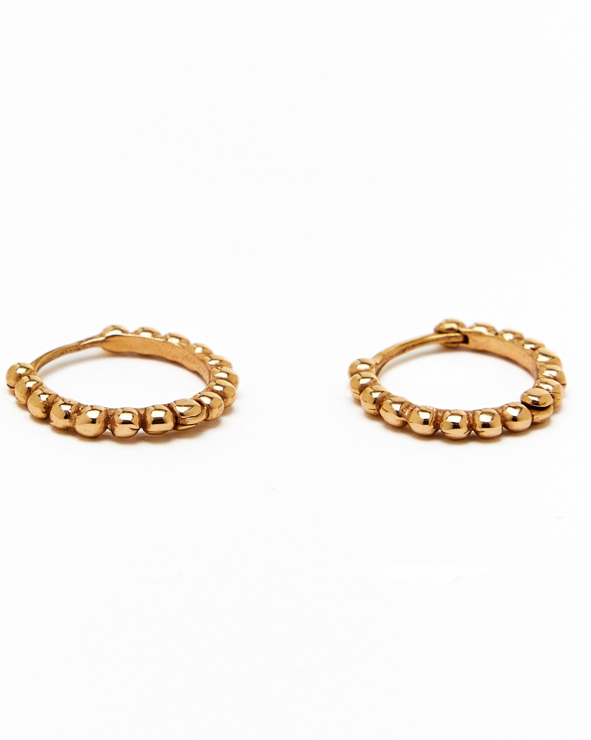 A pair of gold hoop earrings with a beaded design, made to order.