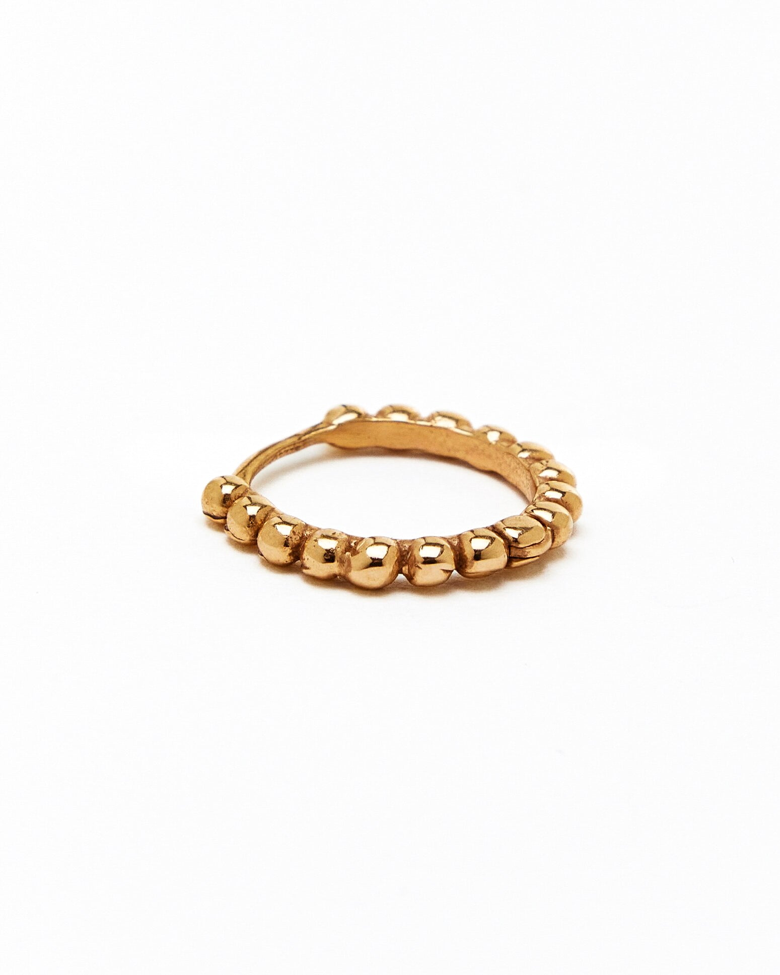a gold hoop earring with a beaded design, made to order.