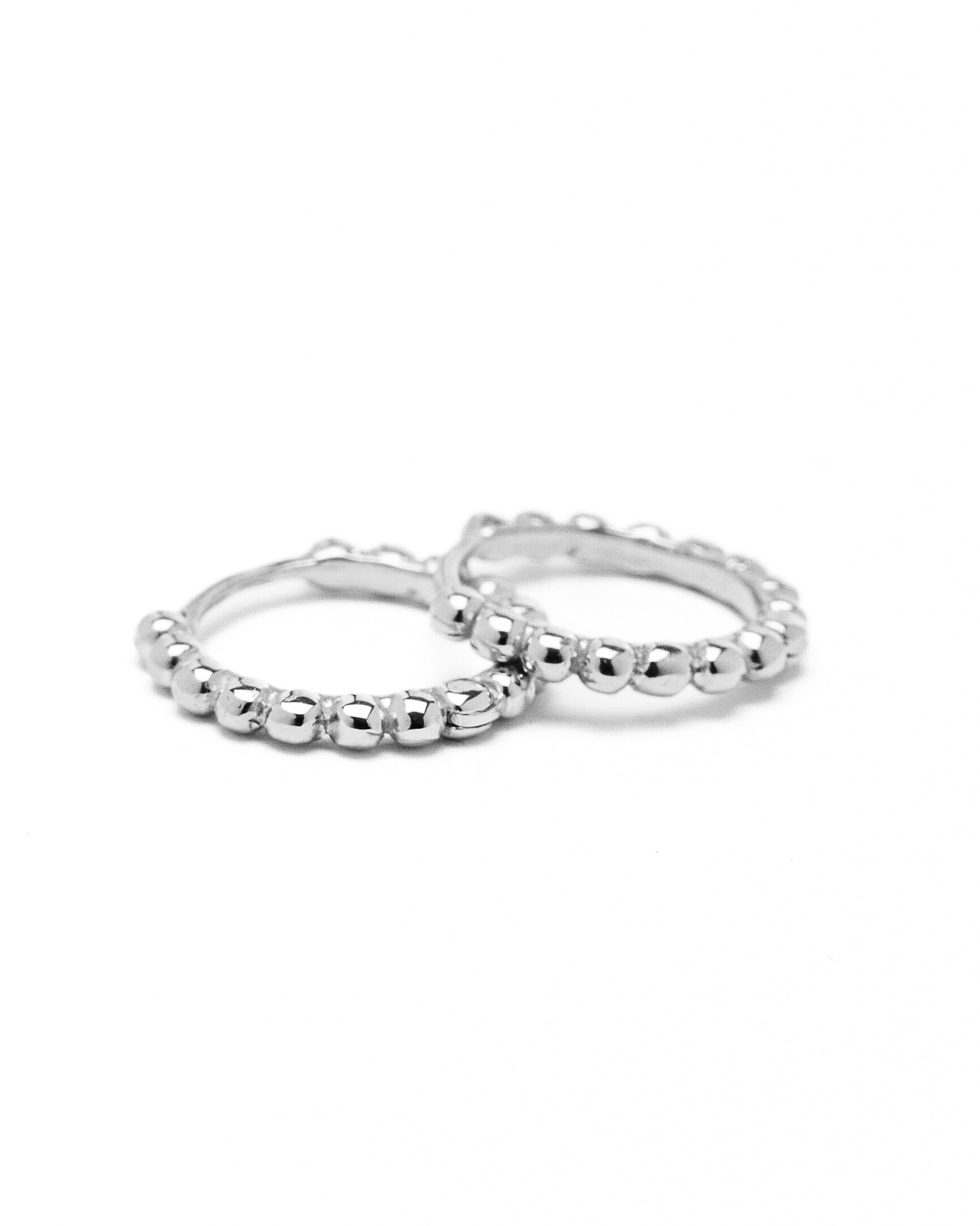 A pair of gold hoop earrings with a beaded design, made to order.