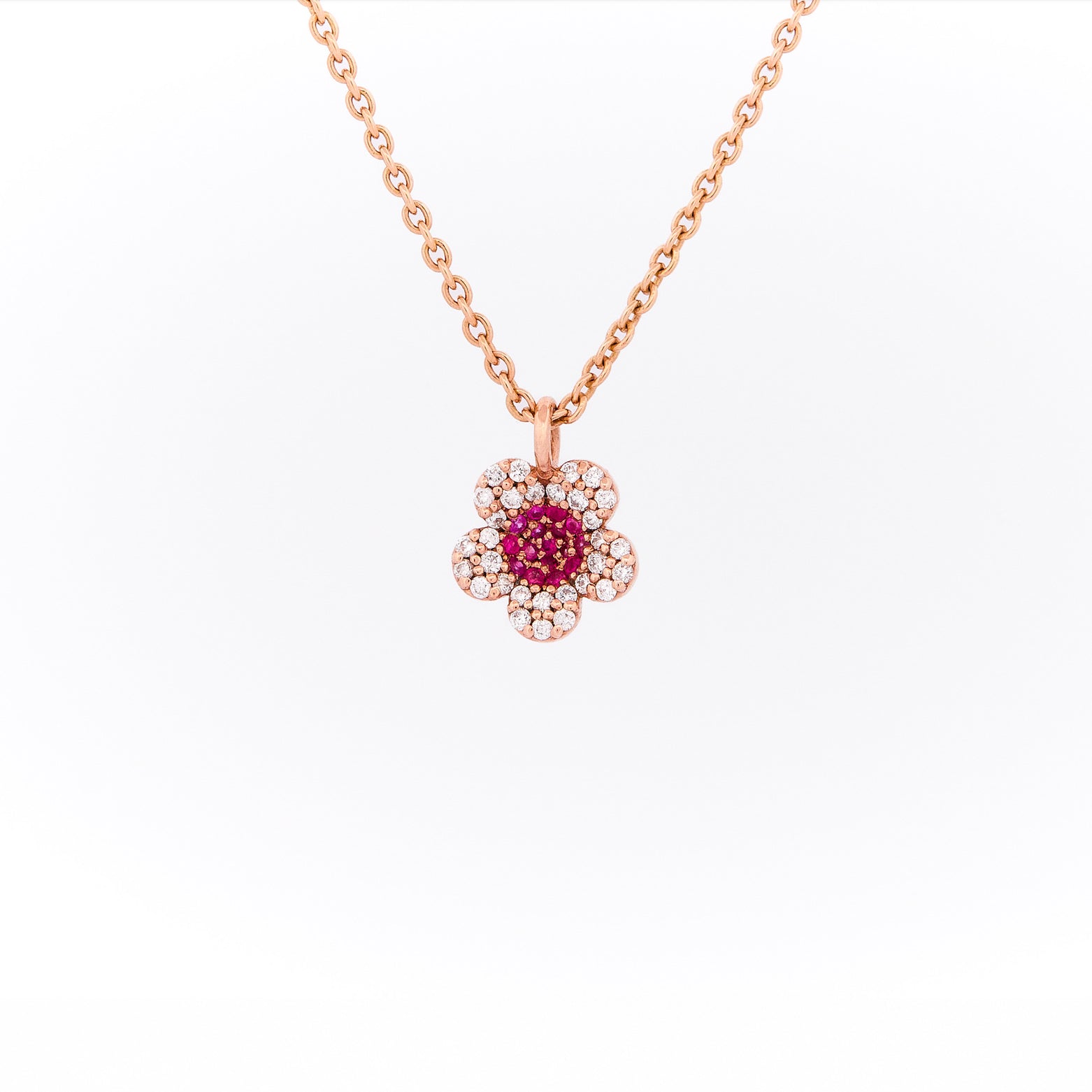 Rose gold necklace with a floral pendant on a white background