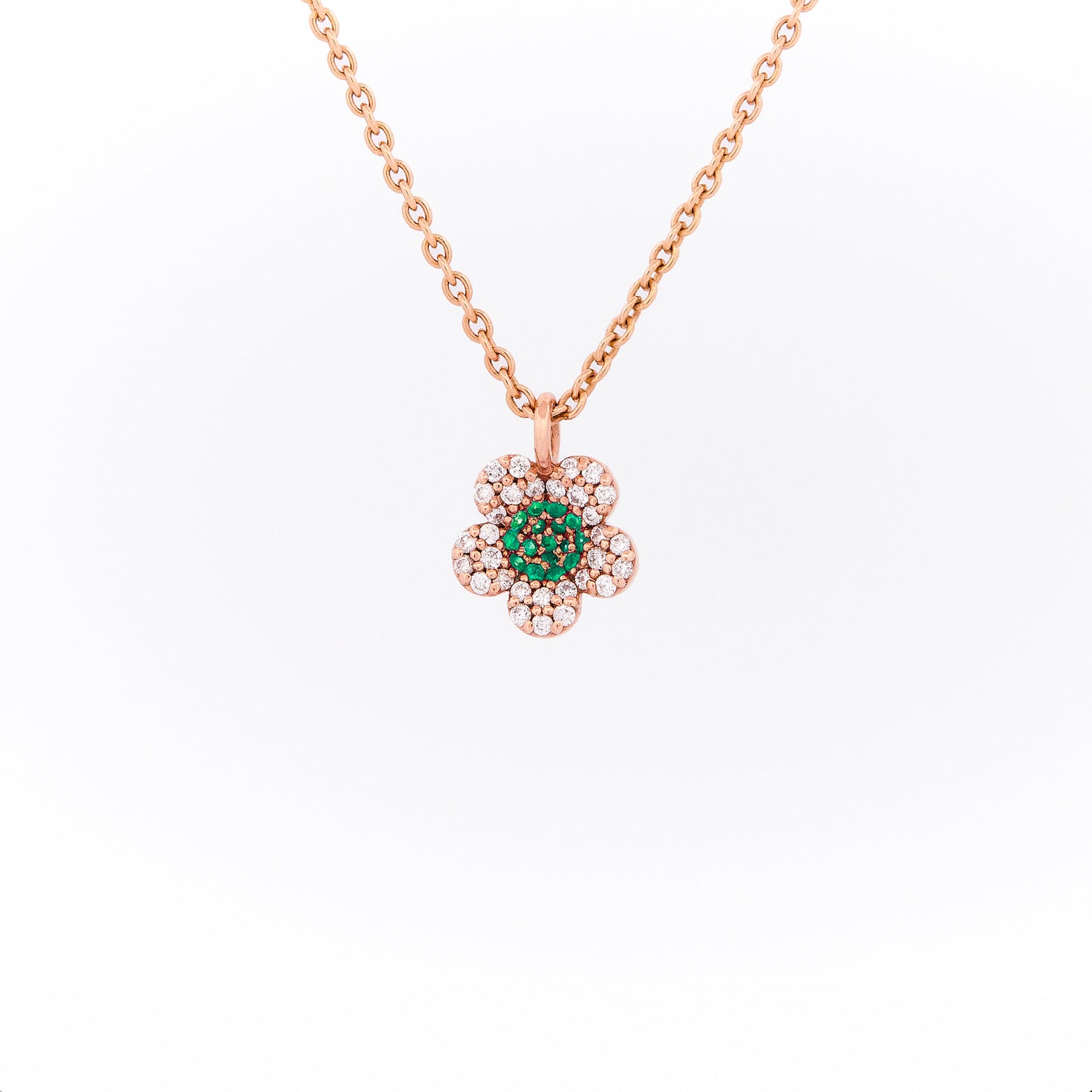 Rose gold necklace with a green gemstone pendant on a white background