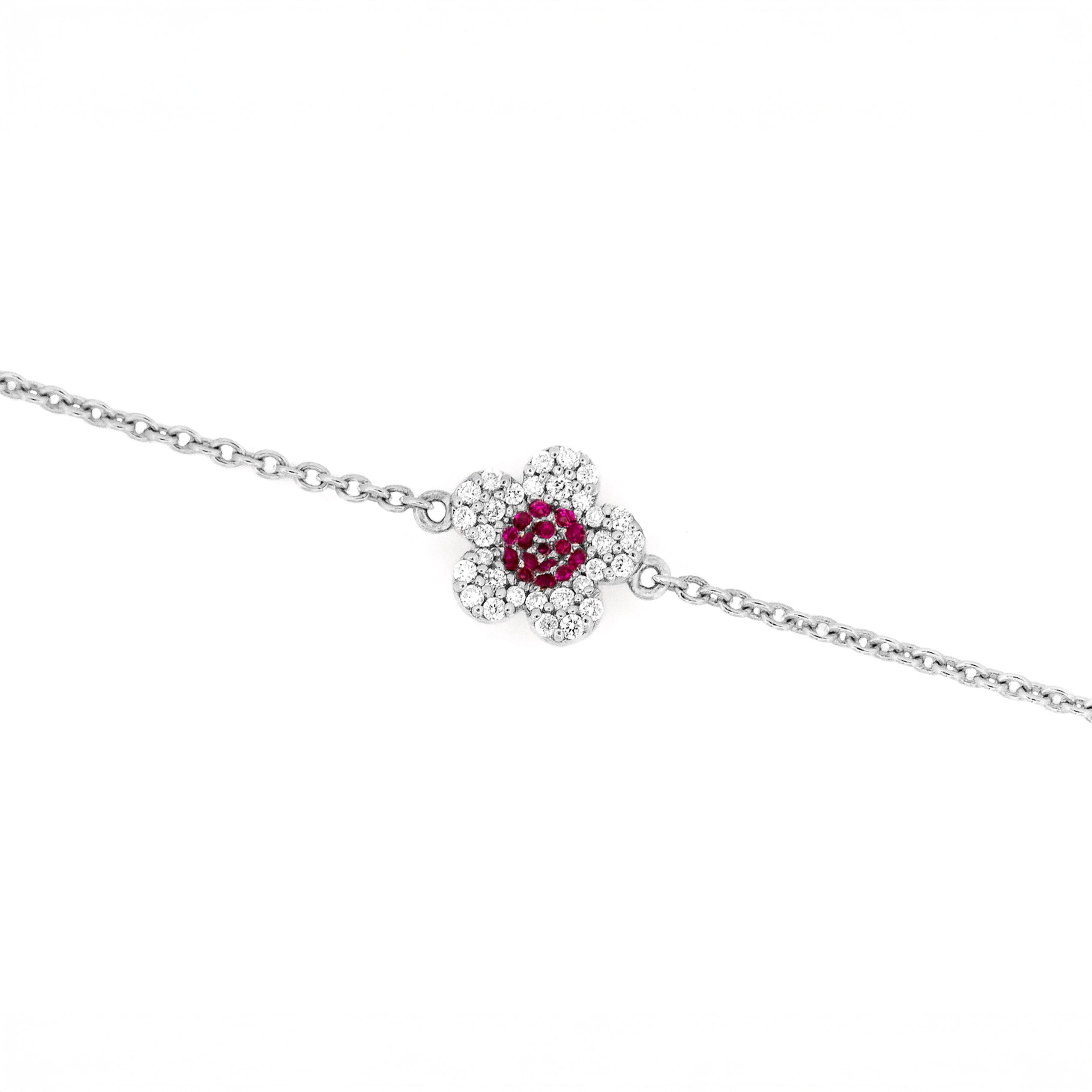 White gold bracelet with a ruby and diamonds flower on a white background