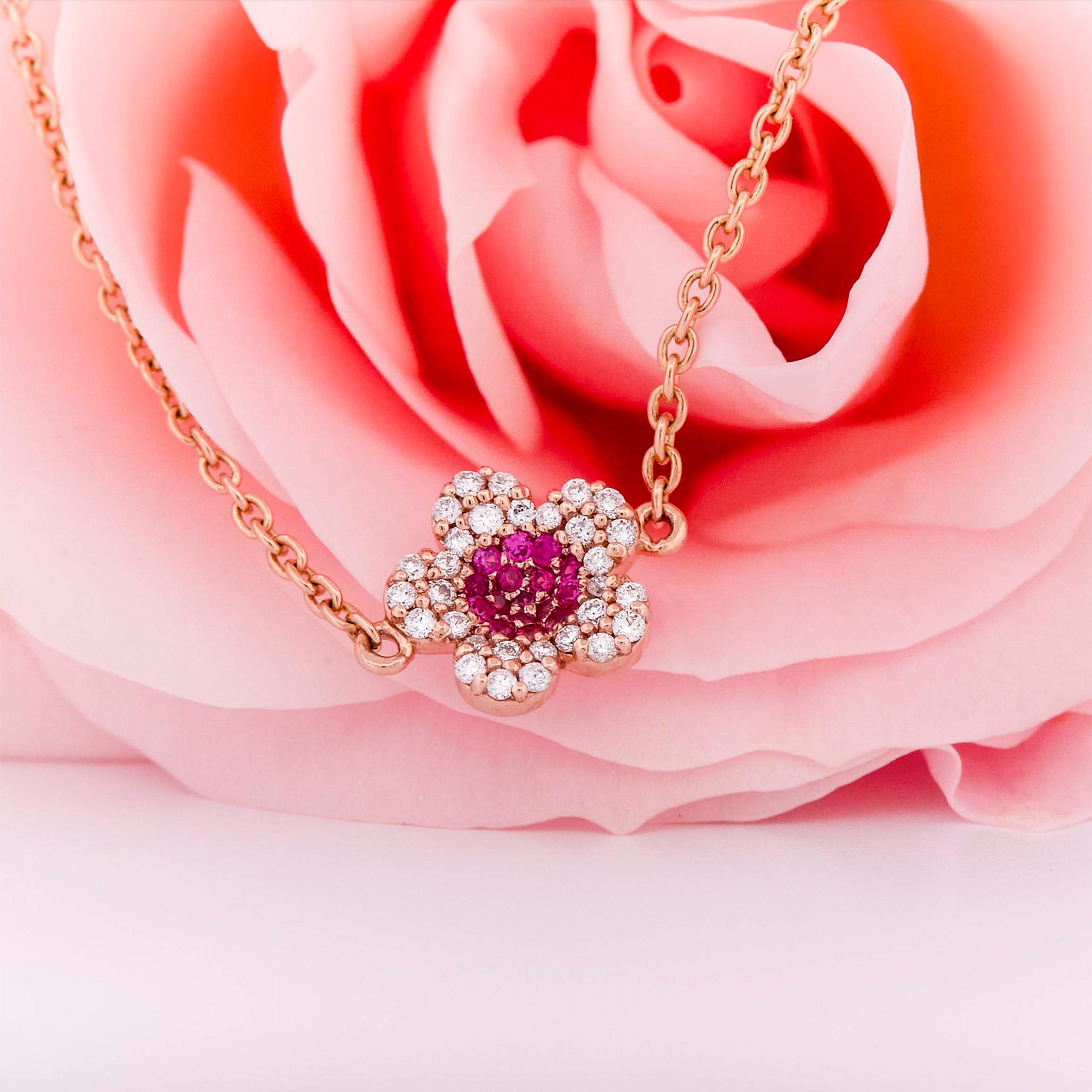 Rose gold bracelet with a ruby and diamonds flower on a rose