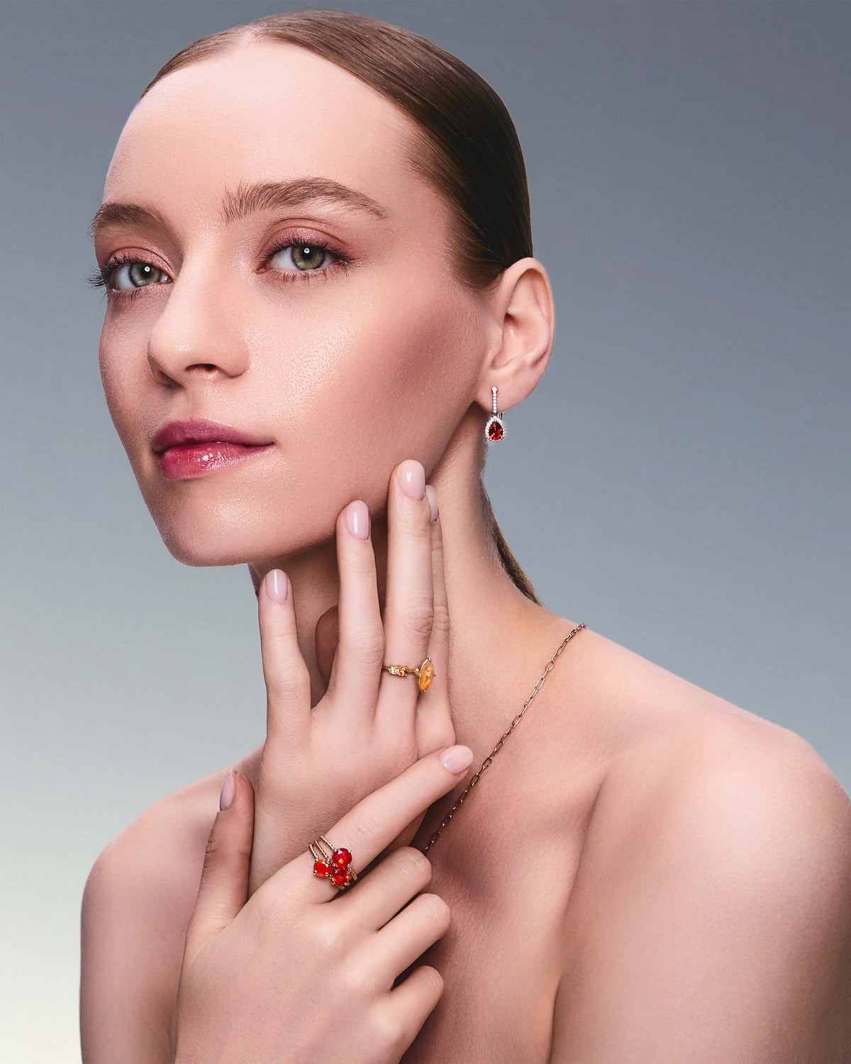 teardrop earring in red gold with diamonds and a teardrop fiery citrine on beautiful model. Also wearing mexican fire opal rings.