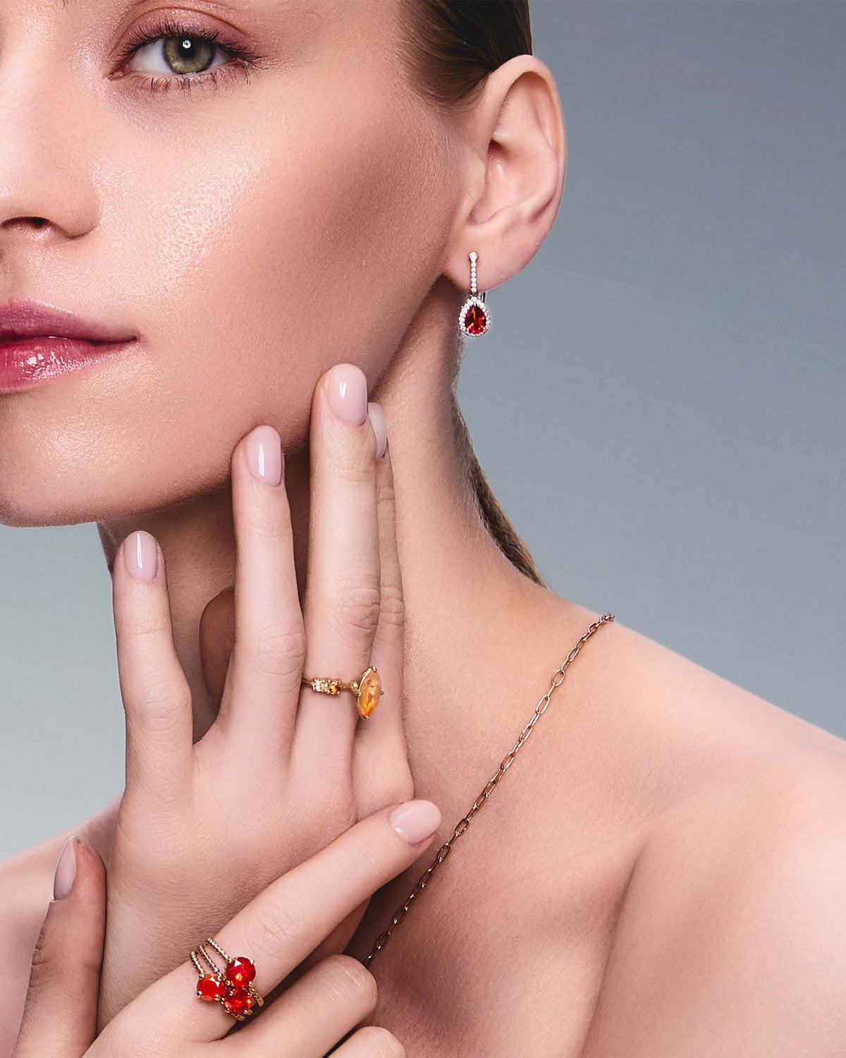 teardrop earring in red gold with diamonds and a teardrop fiery citrine on beautiful model. Also wearing mexican fire opal rings.