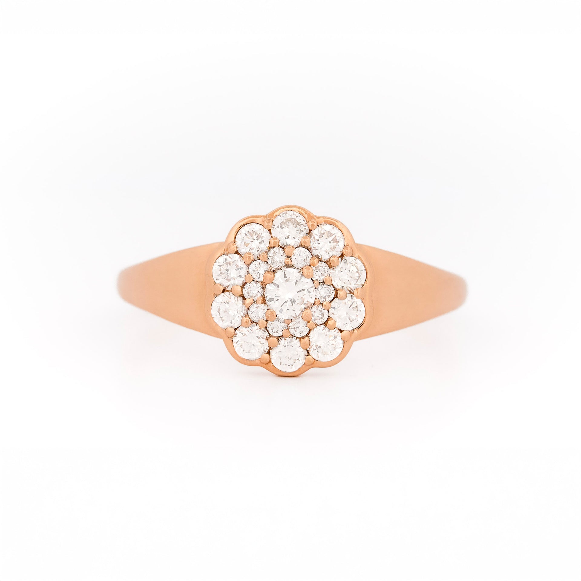 Rose gold ring with diamond cluster daisy flower on a white background