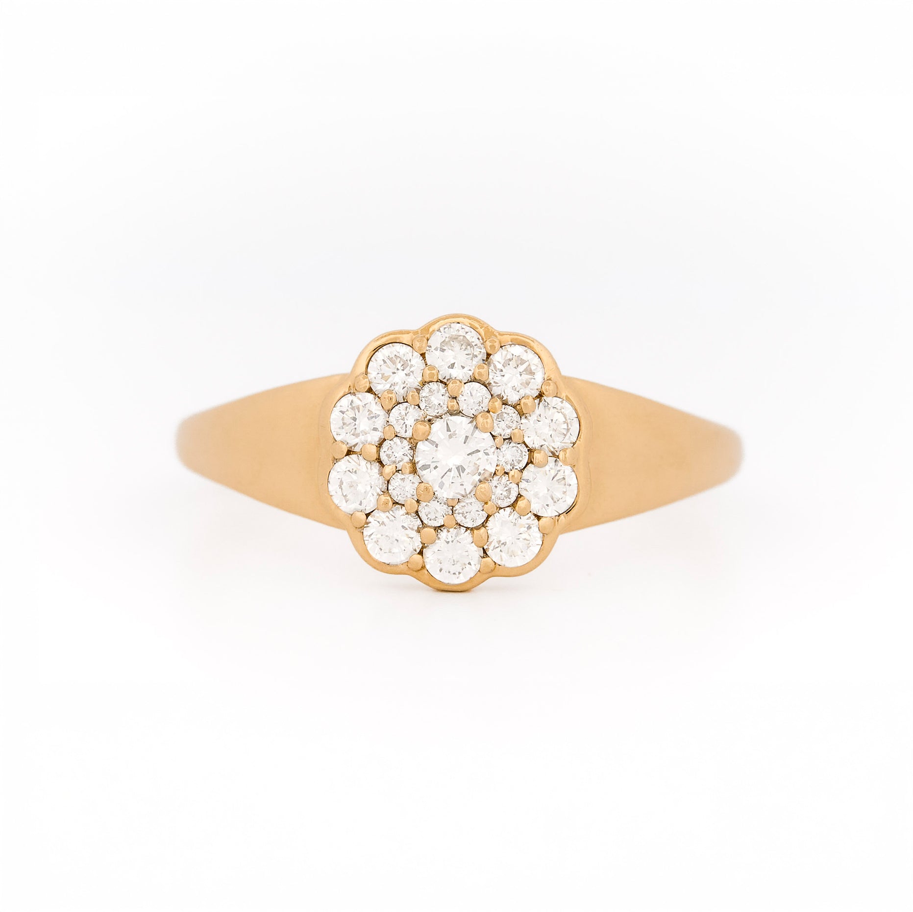 Yellow gold ring with diamond cluster daisy flower on a white background