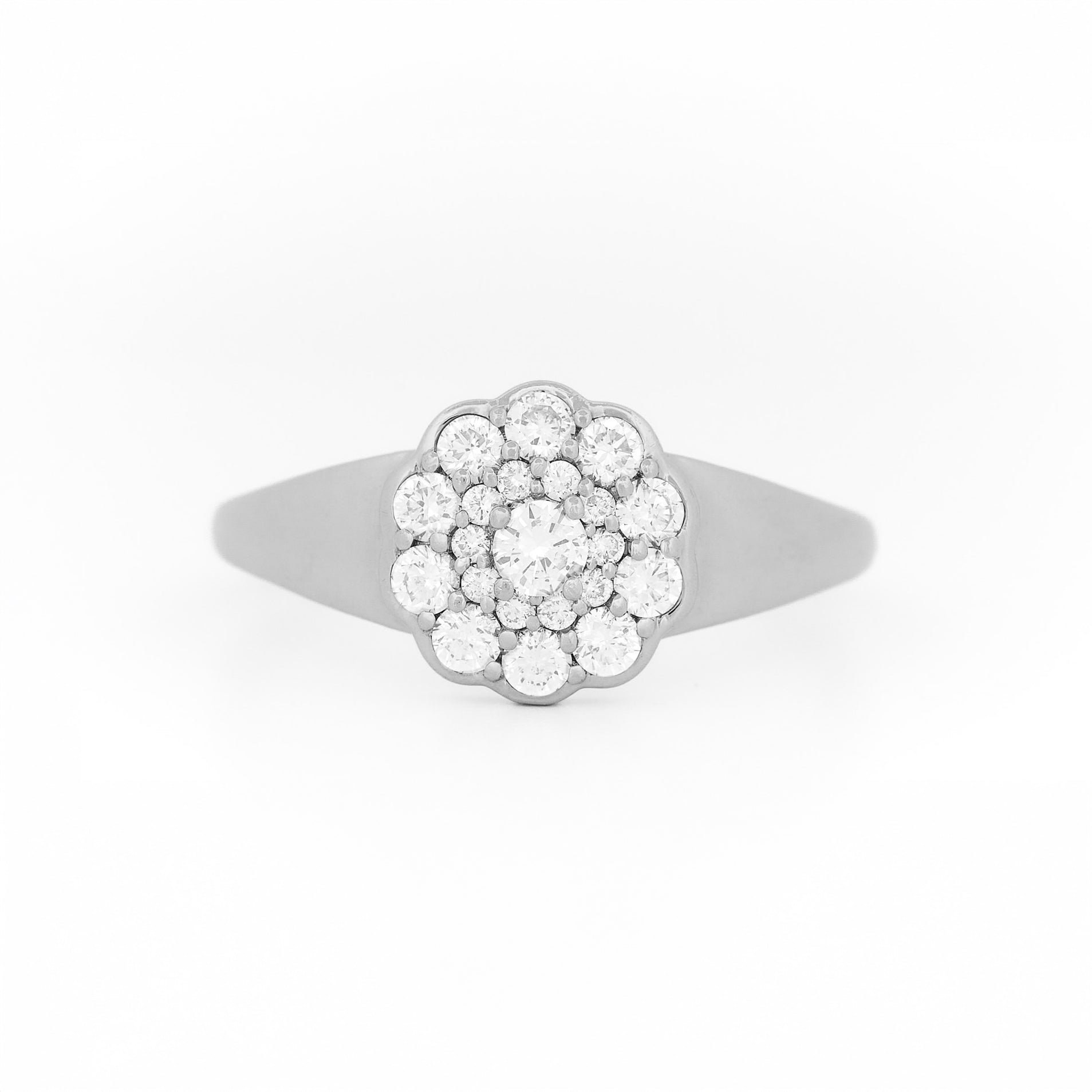 White gold ring with diamond cluster daisy flower on a white background