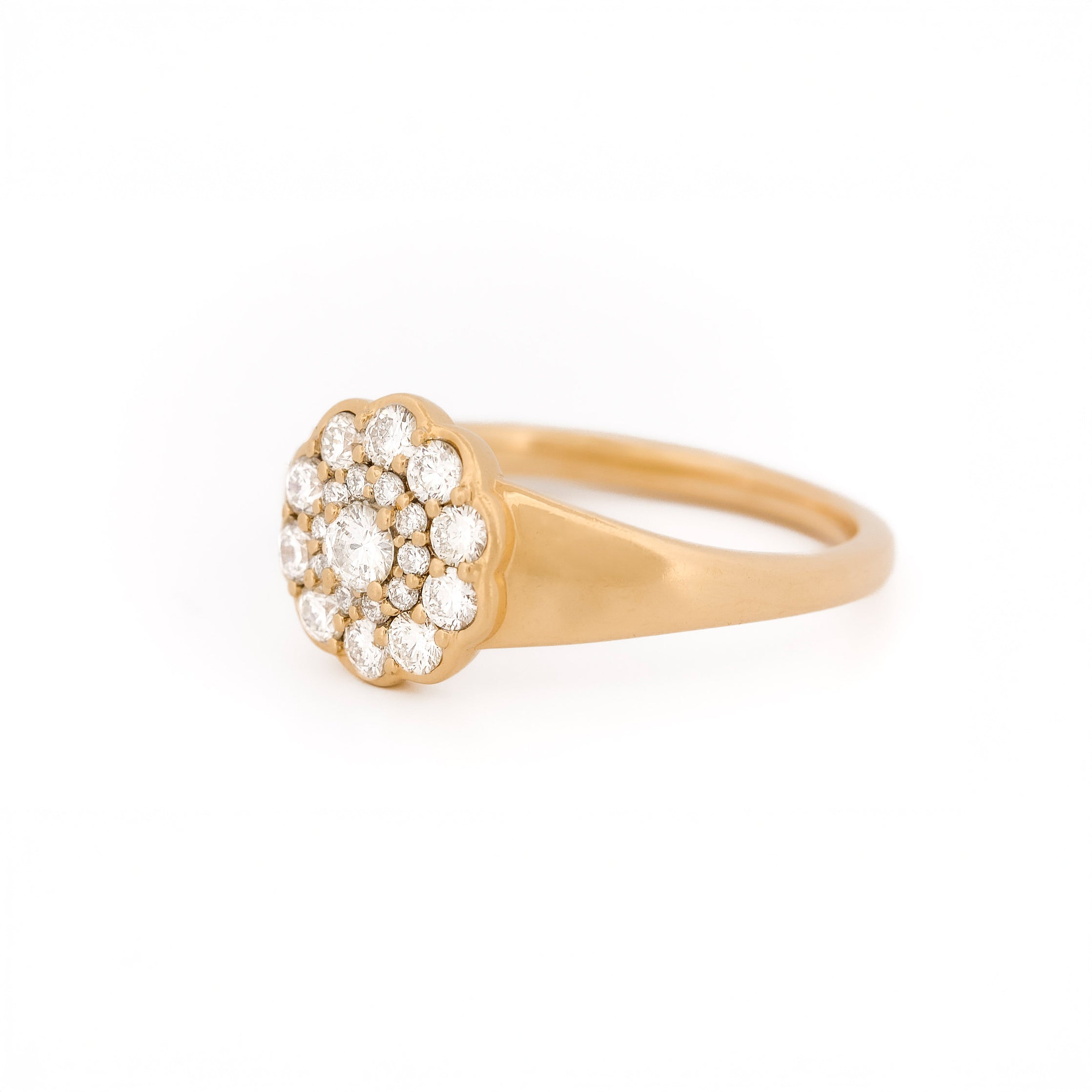 Yellow gold ring with diamond cluster daisy flower on a white background