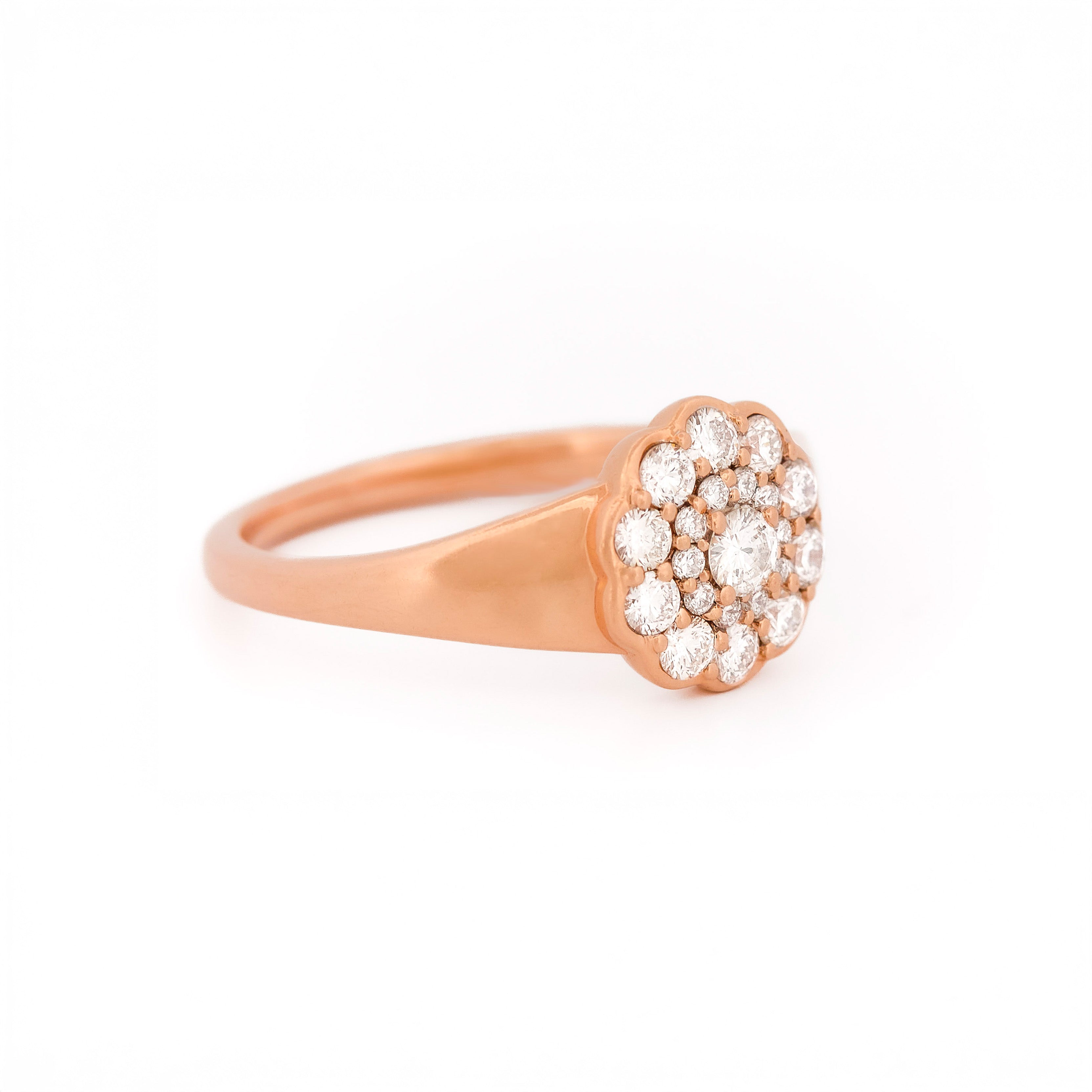 Rose gold ring with diamond cluster on a white background