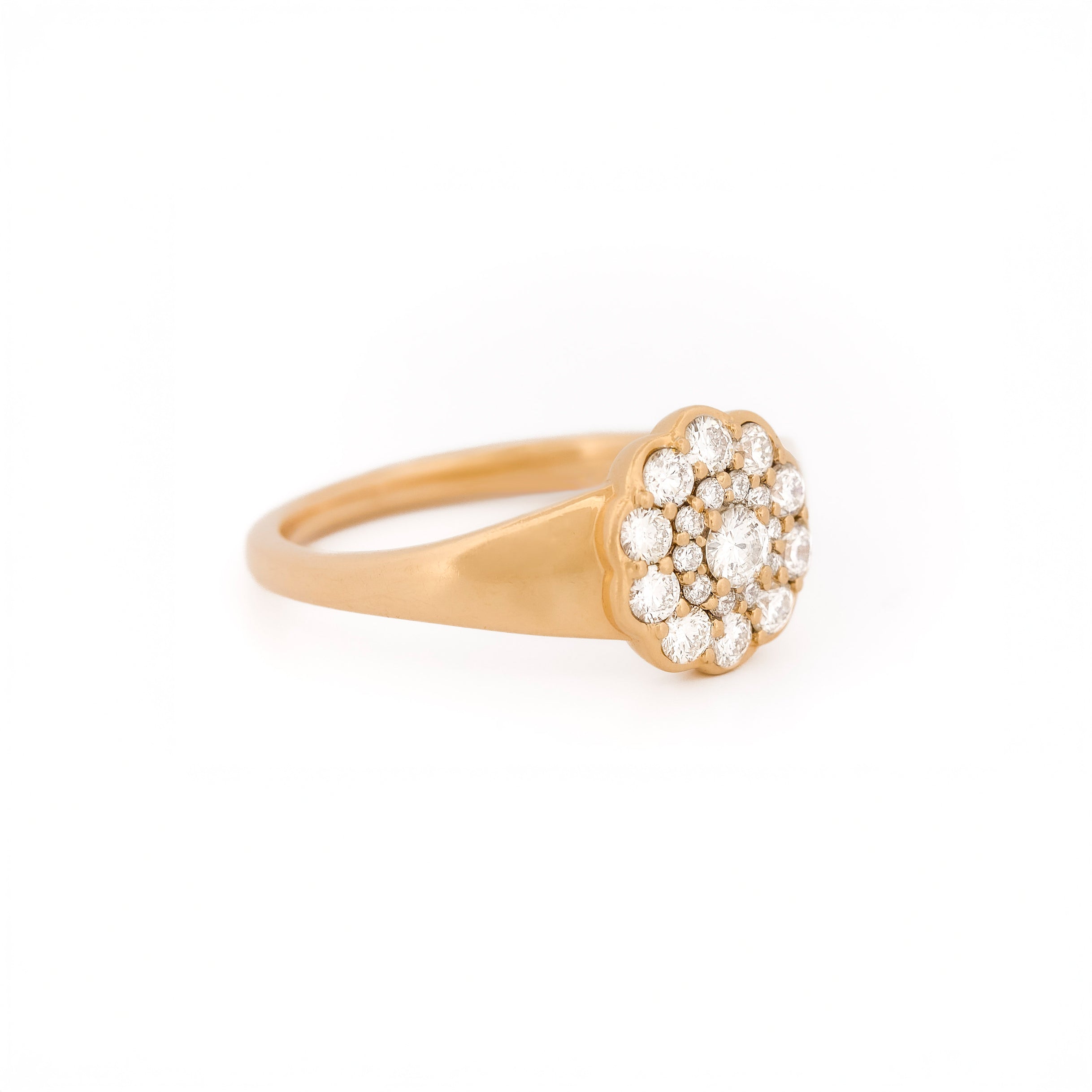 Yellow gold ring with diamond cluster daisy flower on a white background