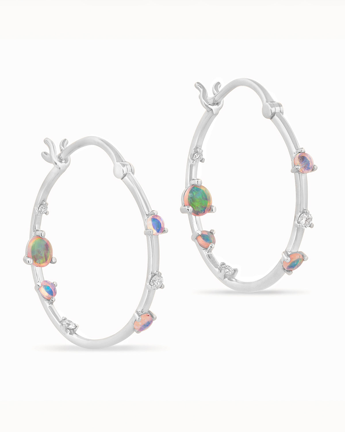 Gold hoop earrings with embedded Australian opals and diamonds on a white background