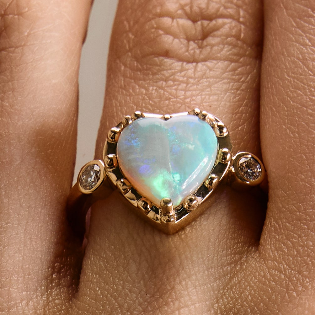 Gold ring with Australian Opal heart on hand