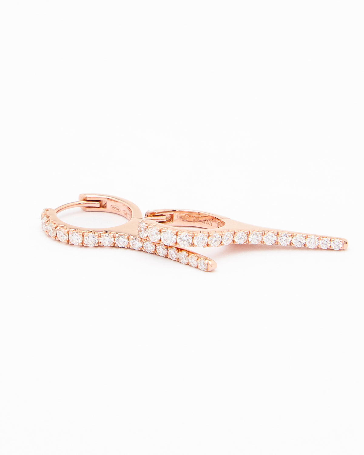 A pair of rose gold earrings with natural diamond drops, featuring a minimalist design.