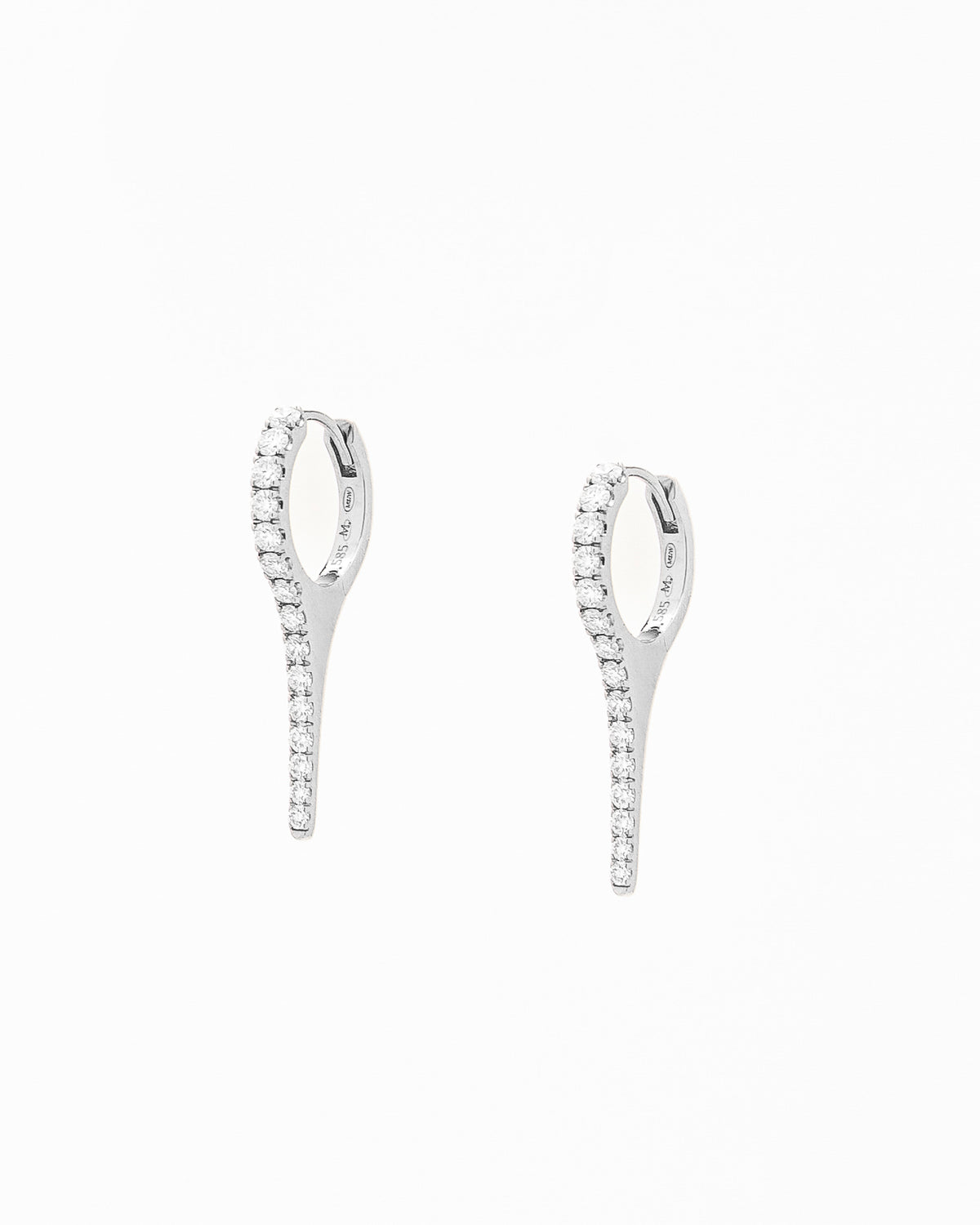A pair of gold earrings with natural diamond drops, featuring a minimalist design.