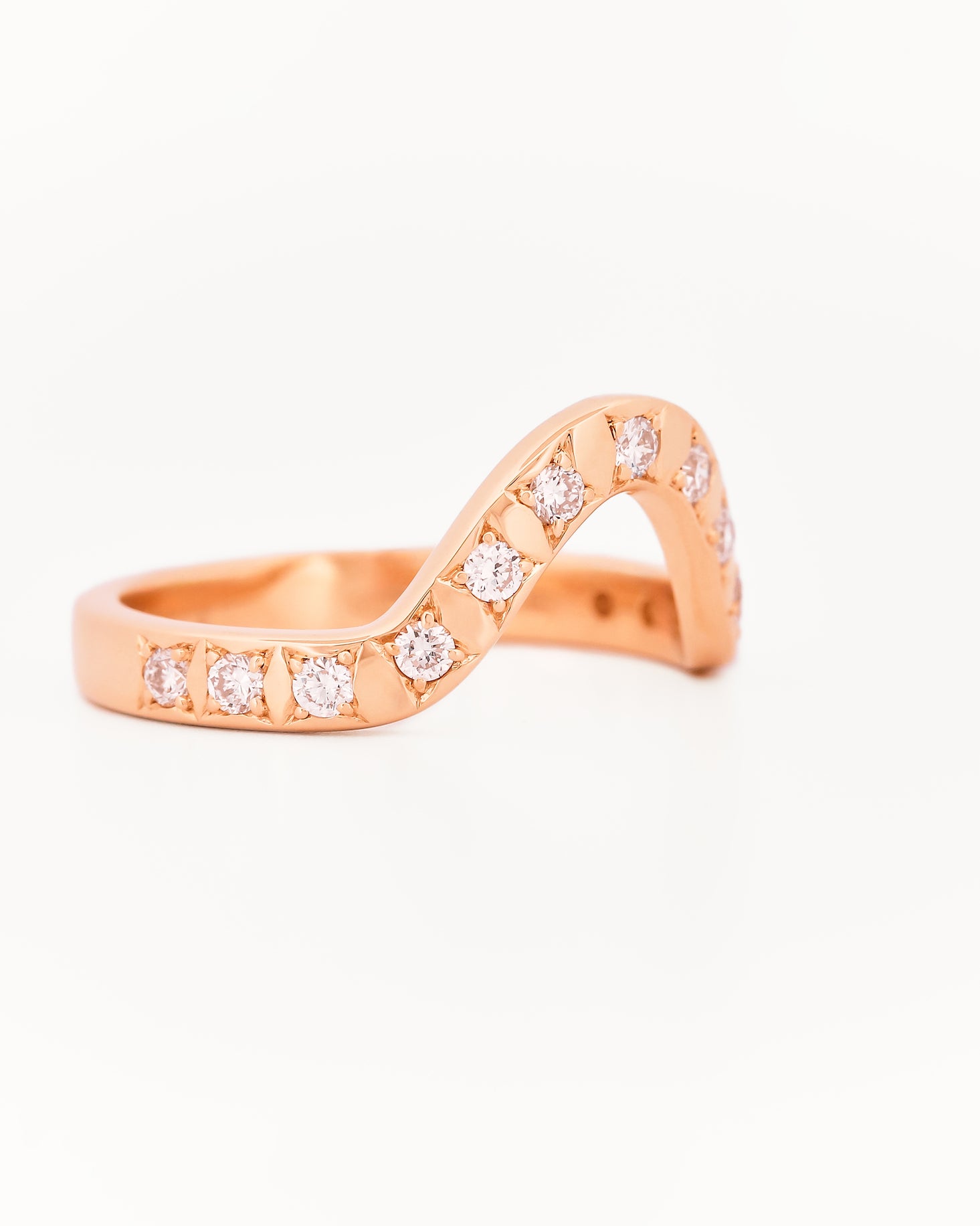 Yellow gold 2.5 mm band ring with 3 round diamondsdiamonds on a white background.