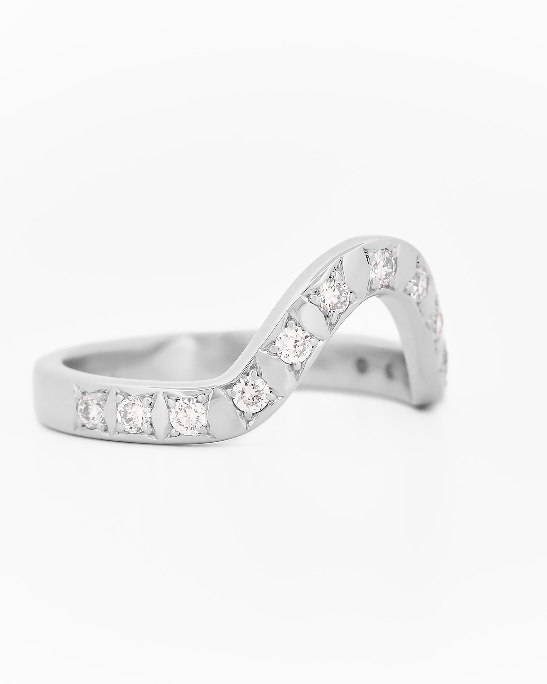 White gold 2.5 mm band ring with 3 round diamondsdiamonds on a white background.