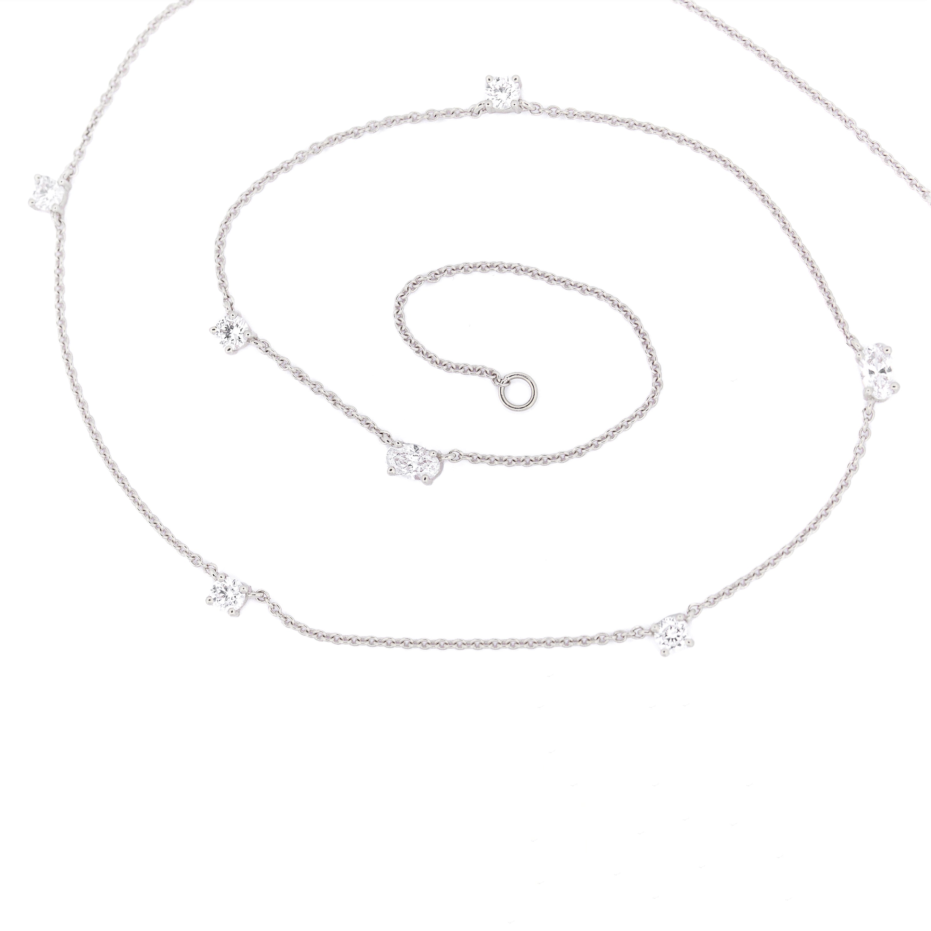 white gold chain necklace with round and oval diamonds on a white background