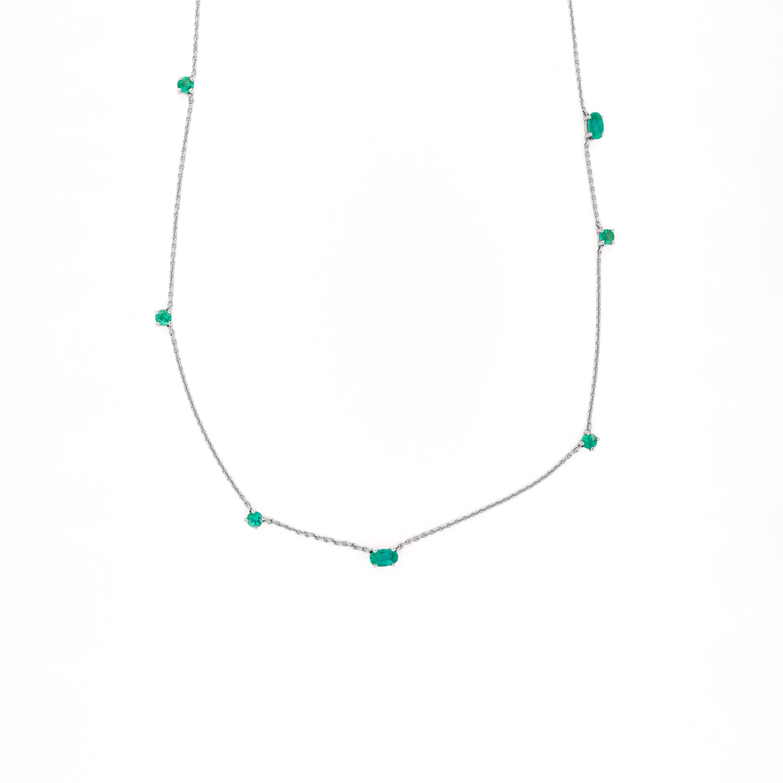 Necklace with emeralds gemstones on a white background