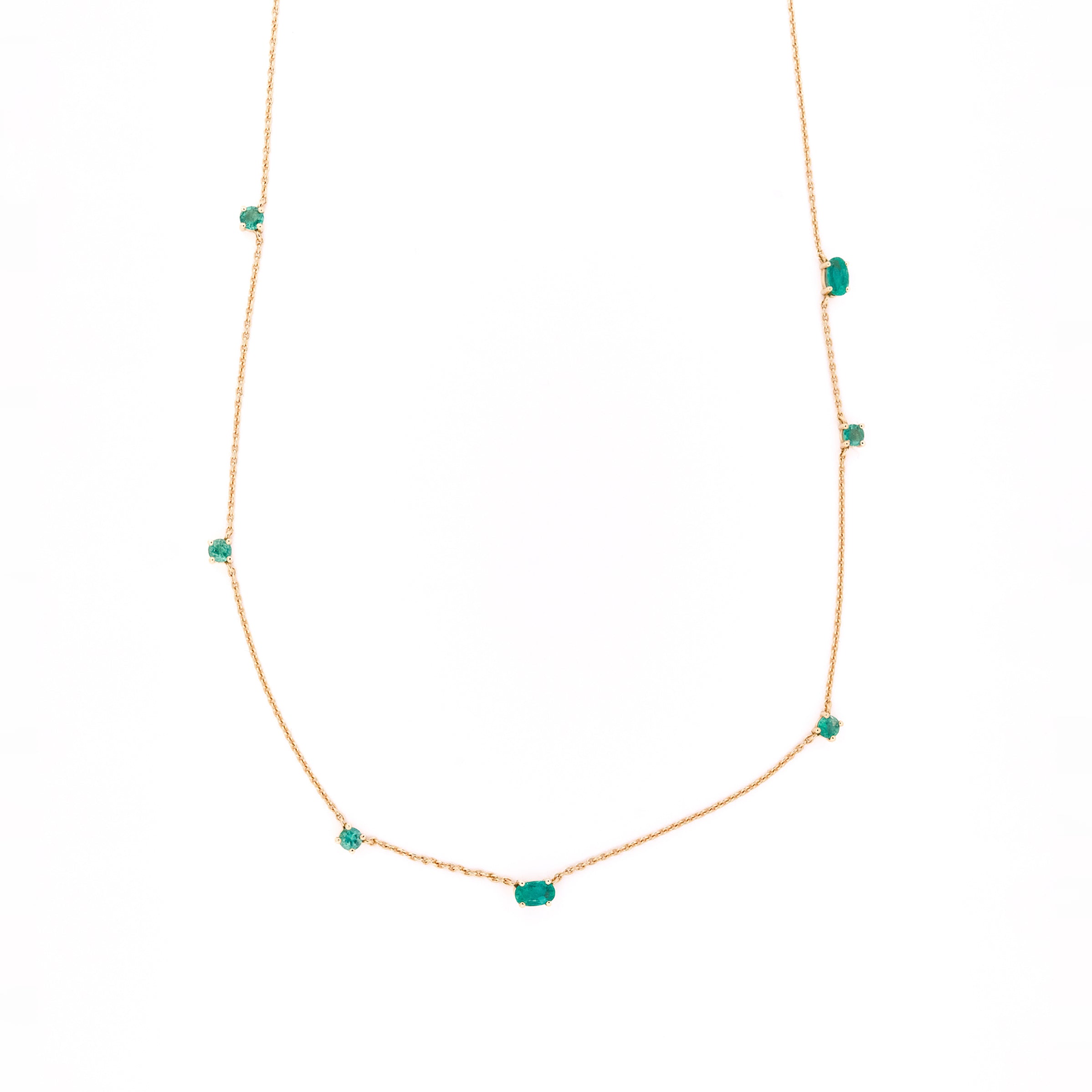 Necklace with emeralds gemstones on a white background