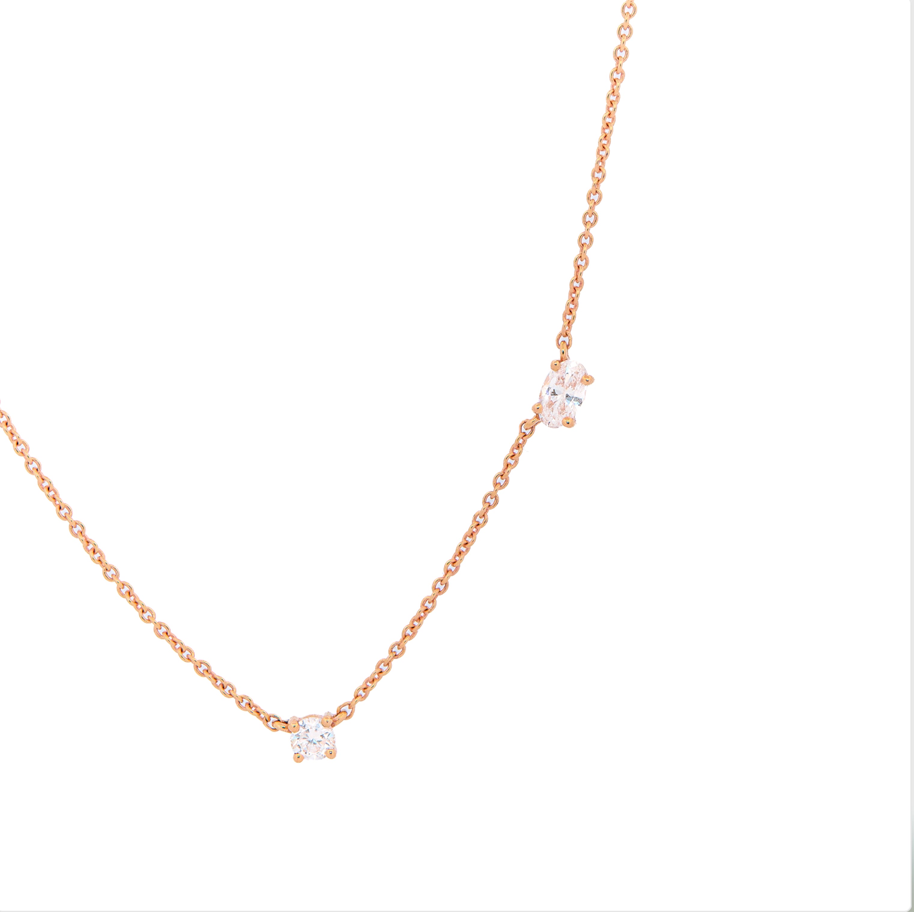 Rose gold necklace with small diamonds on a white background