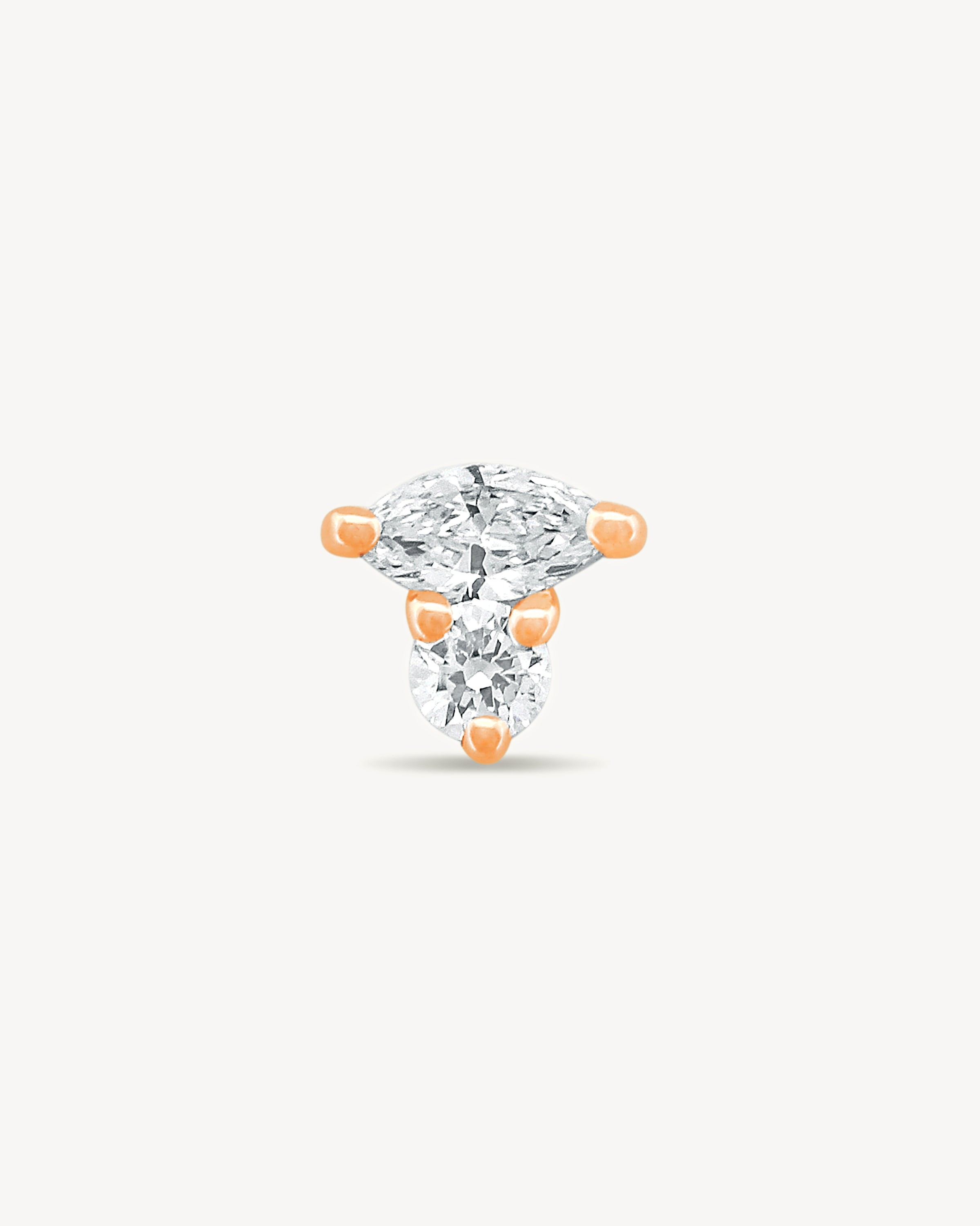 Rose gold Marquise and round Diamond stud earring with on a light gray background