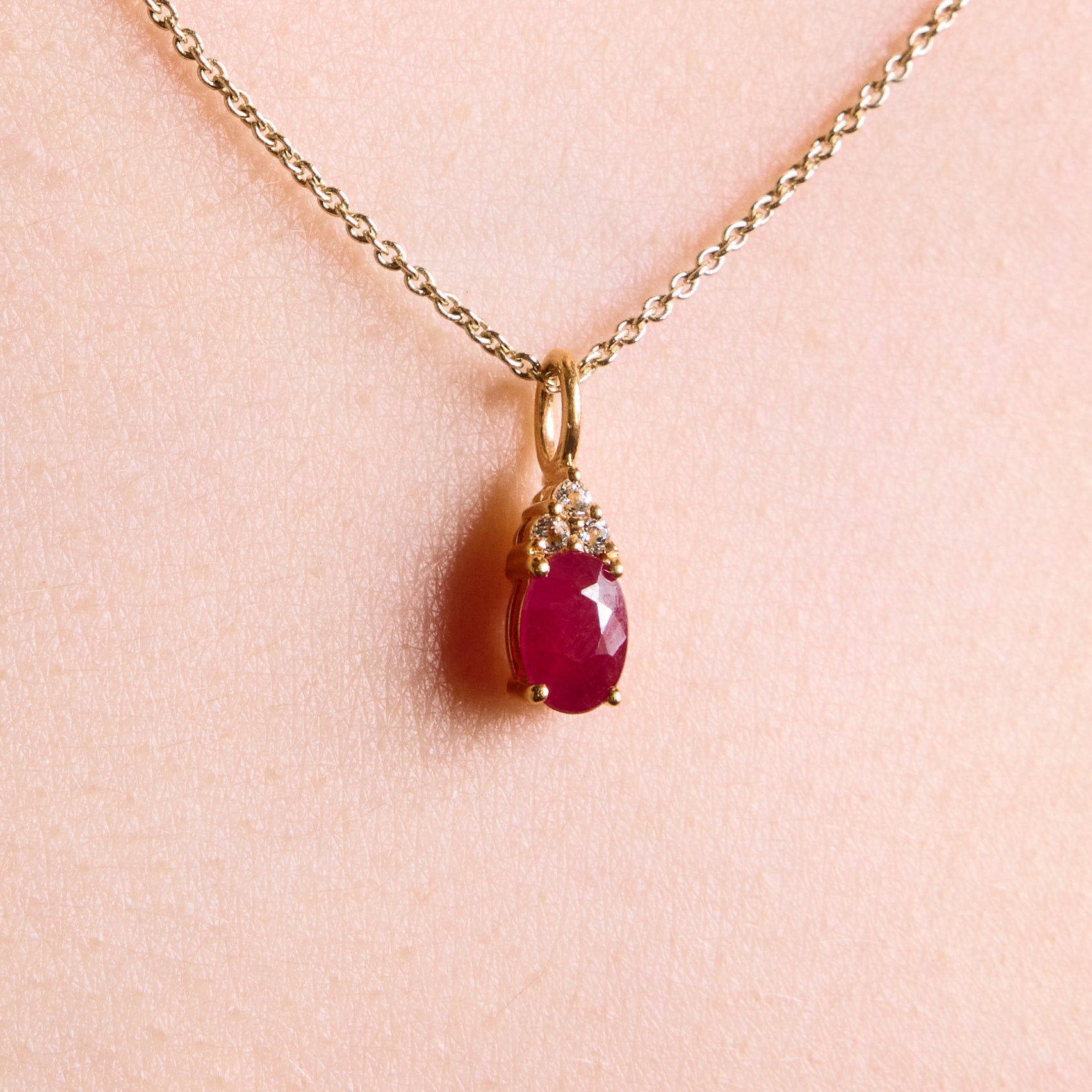 ruby pendant, ruby and diamonds pendant, ruby and diamonds pendant on chain, ruby, ruby and diamonds pendant in yellow gold on model close up