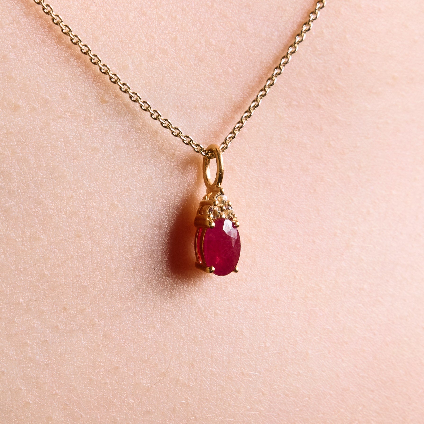 ruby pendant, ruby and diamonds pendant, ruby and diamonds pendant on chain, ruby, ruby and diamonds pendant in yellow gold on model up close