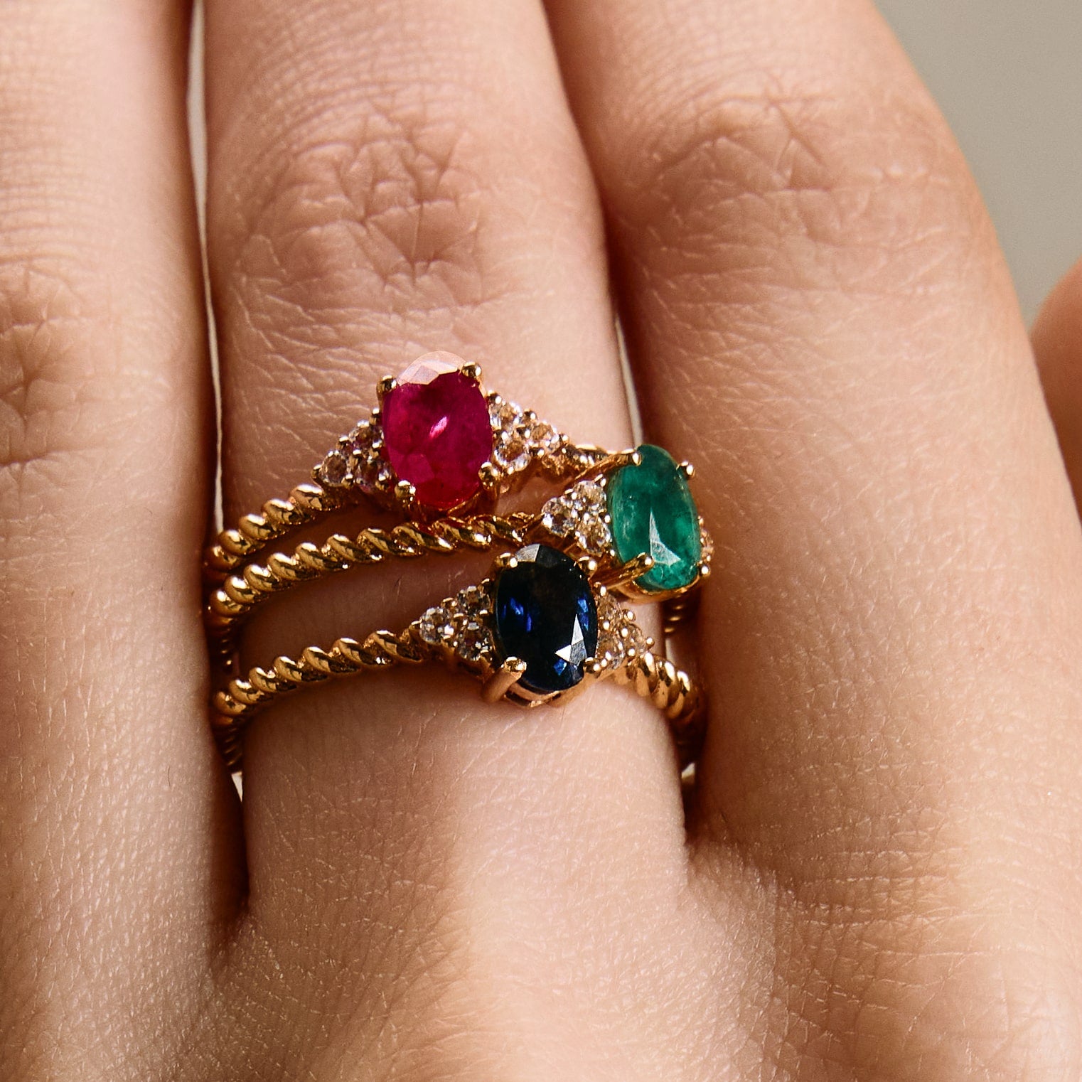 Romantic oval ruby ring with twisted band and cluster diamonds details