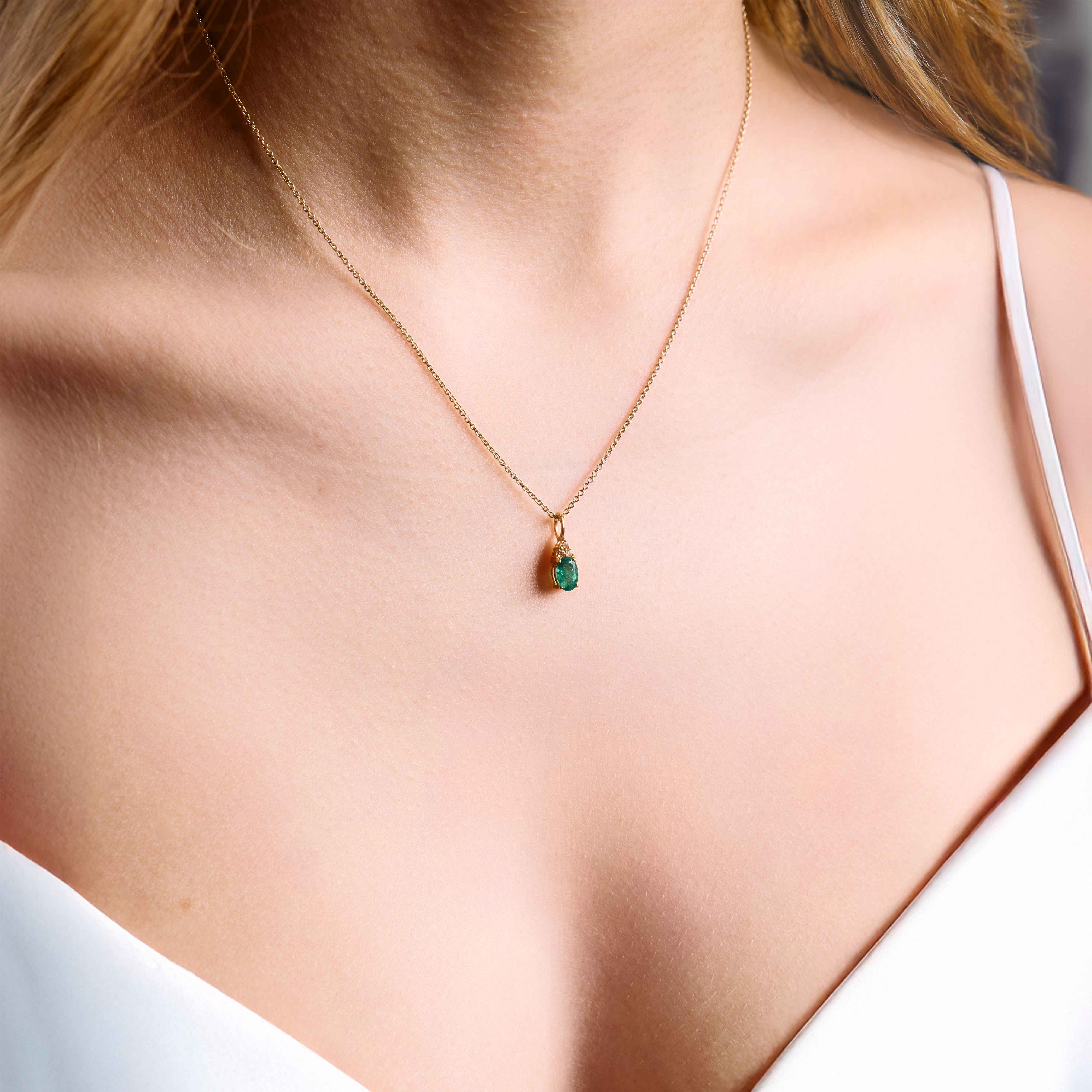 emerald pendant, emerald pendant with diamonds, emerald pendant on string chain, emerald pendant in yellow gold on model