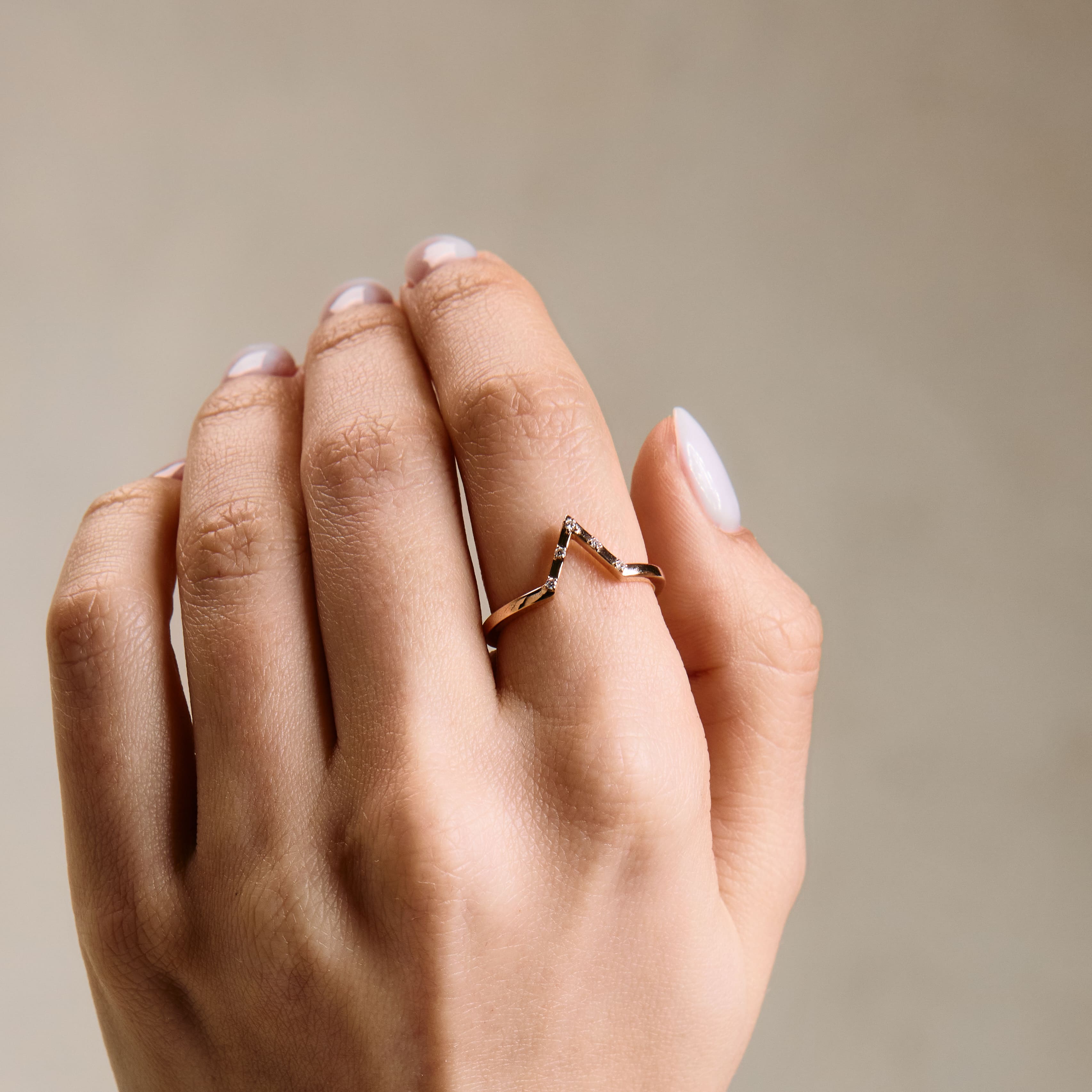 the rose gold Penta wedding band on hand