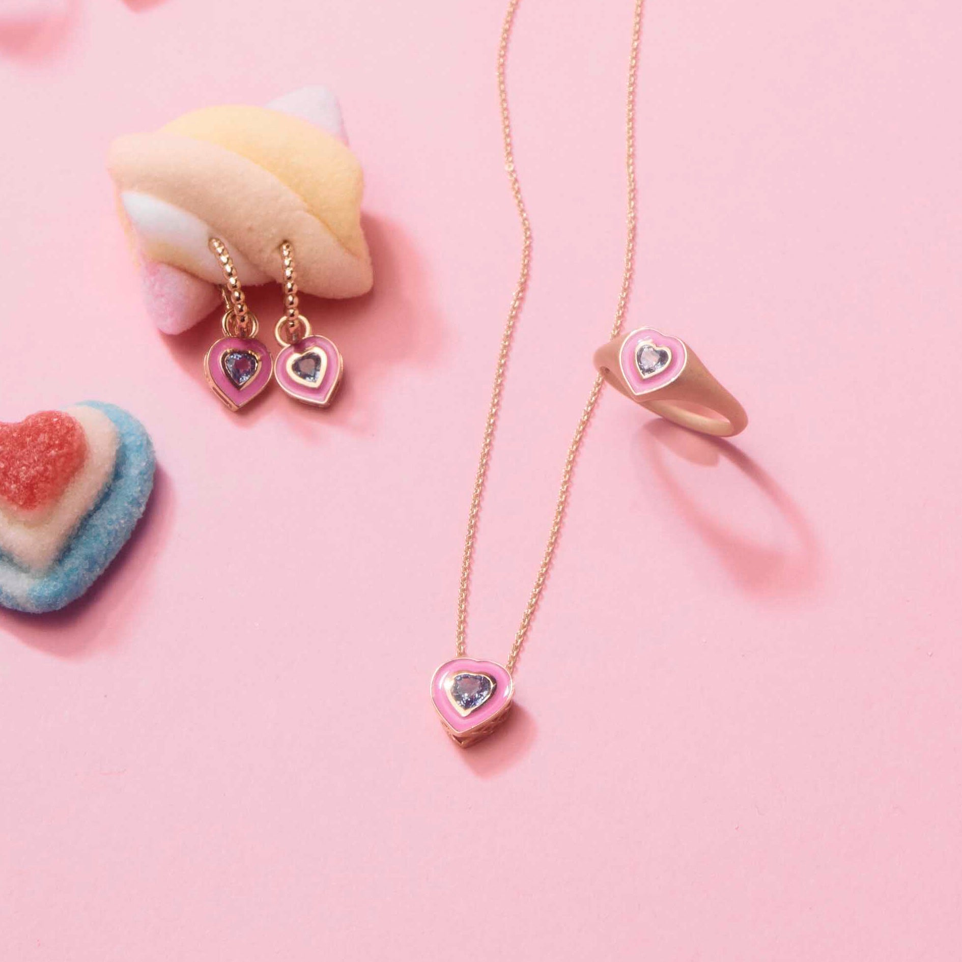 pink enamel gold jewelry, with blue sapphires, surrounded by candy