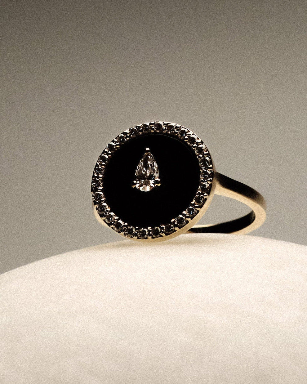 Black Onyx and diamonds Gold Ring on a round marble.