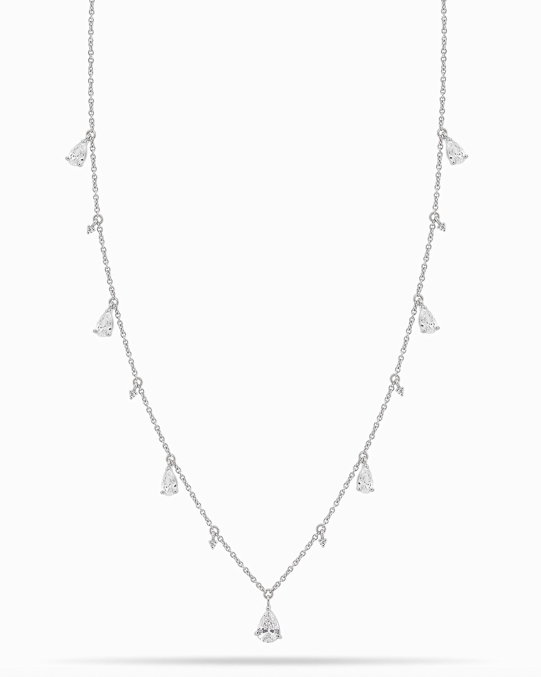 White Gold necklace with teardrop and round diamond pendants on a white background