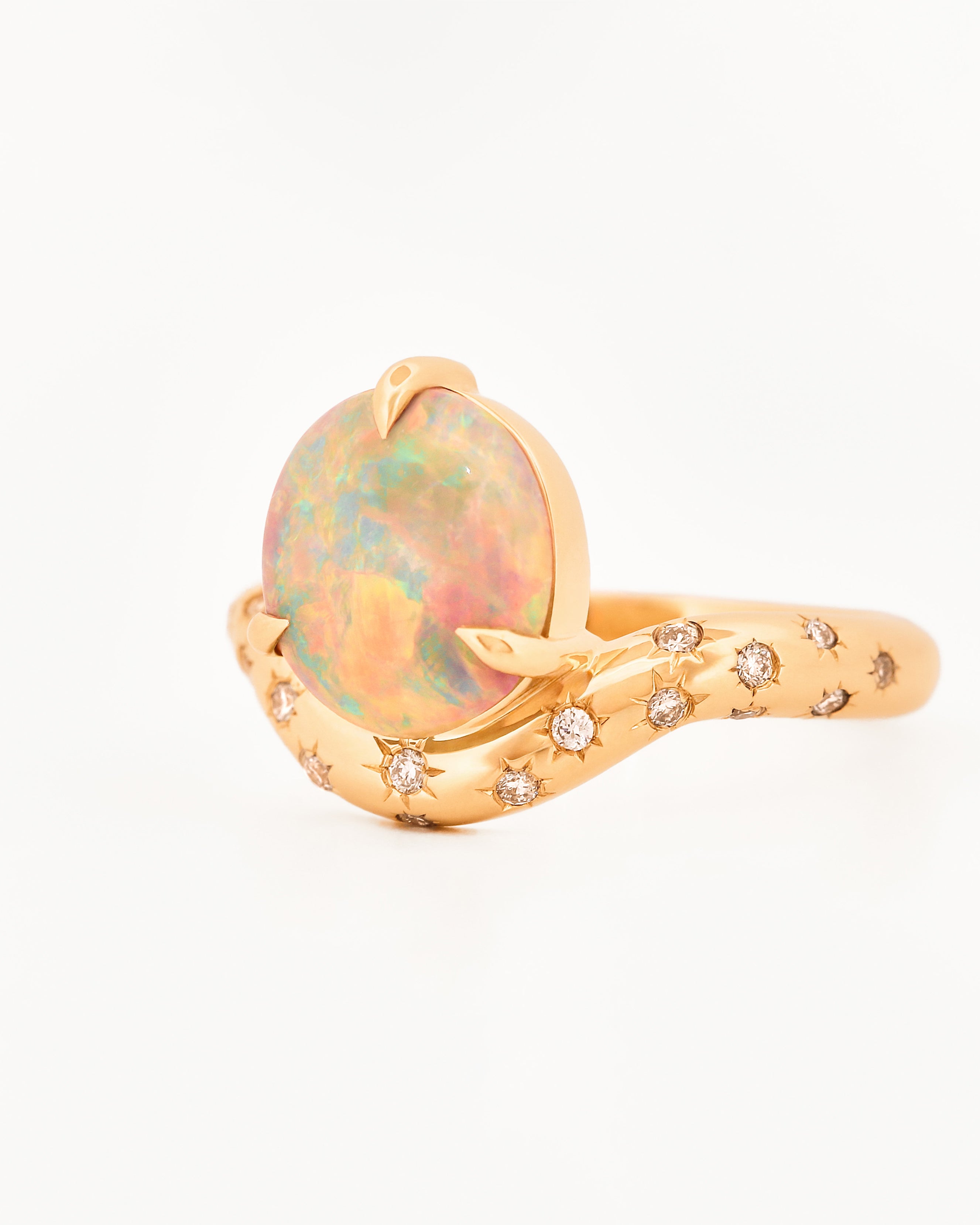 Yellow Gold ring with an australian opal centrestone on a white background.