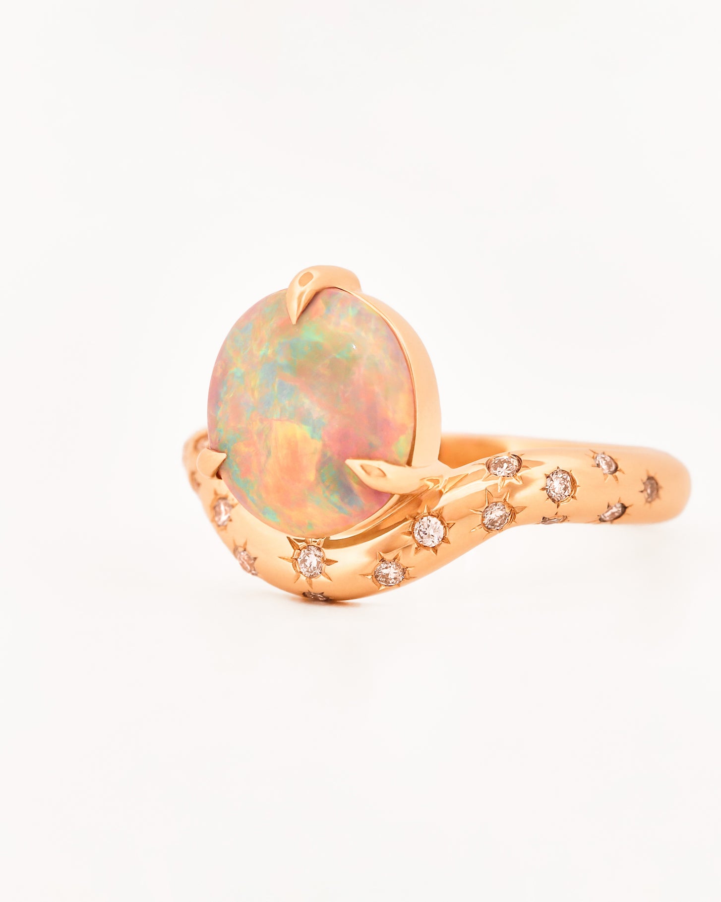 Rose Gold ring with an australian opal centrestone on a white background.
