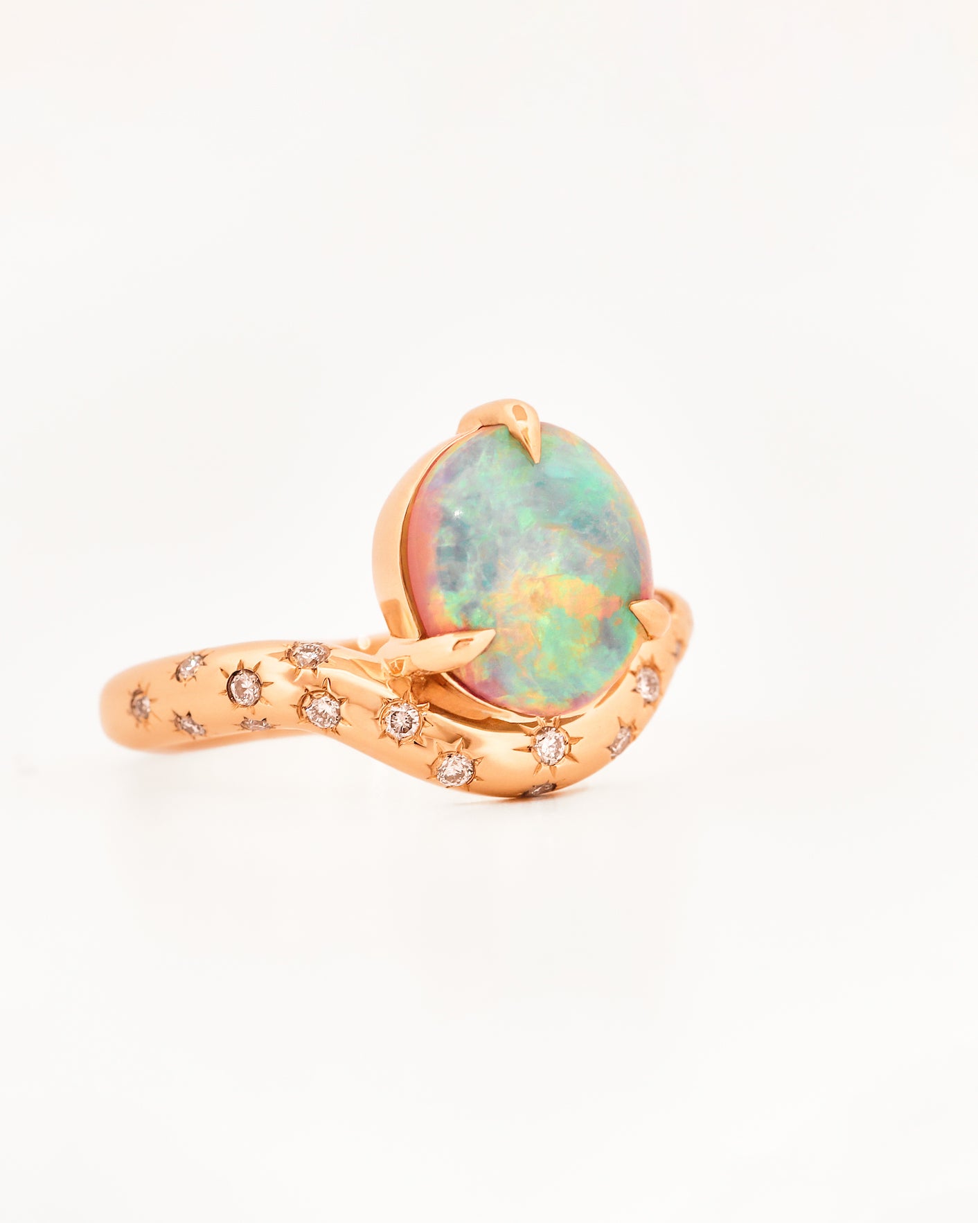 Rose Gold ring with an australian opal centrestone on a white background.